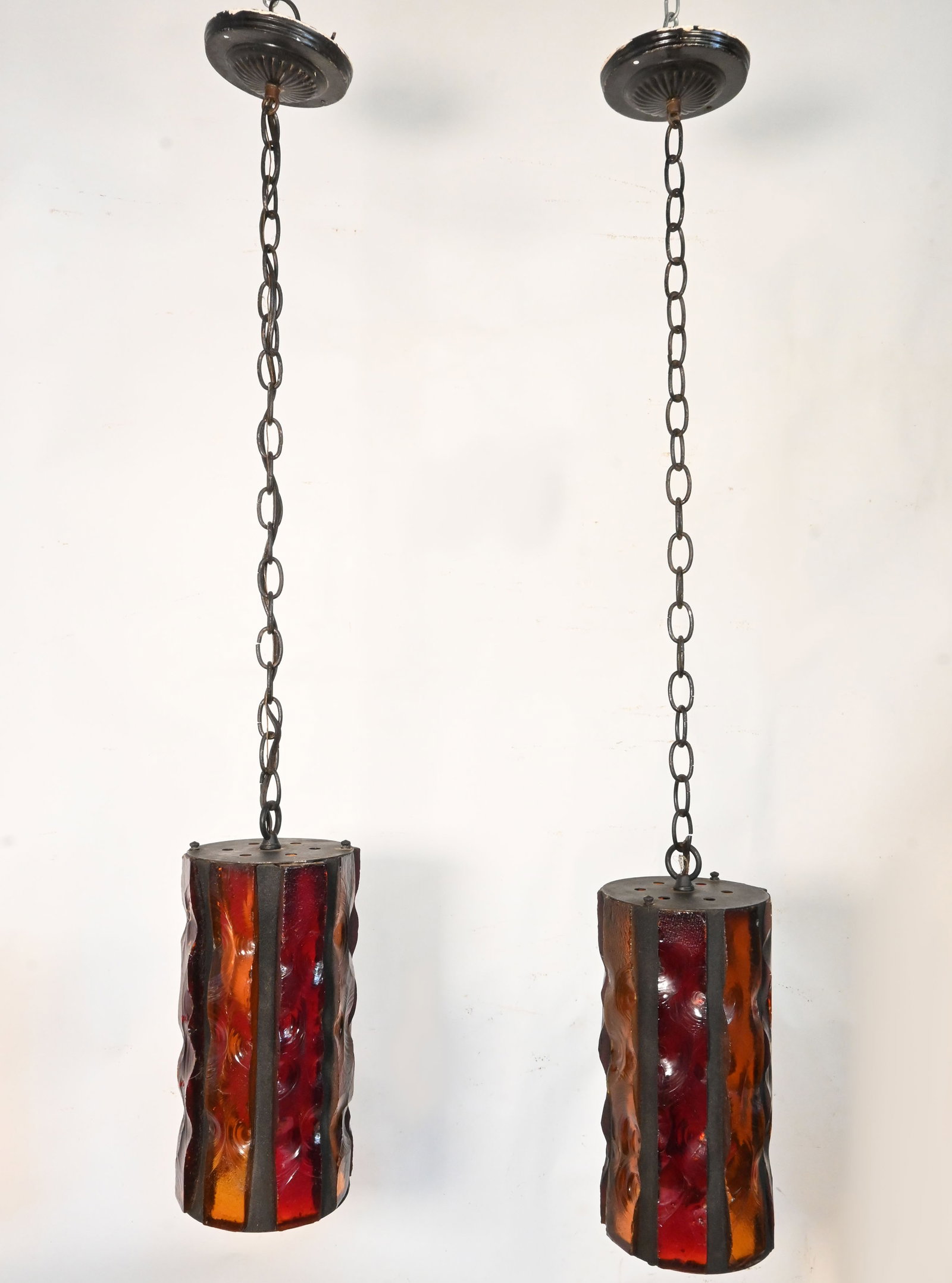 Pair of chunk glass Mid Century Modern pendants: Pair of chunk glass Mid Century Modern pendants. Condition: Age Consistent. Materials: Yellow and Red chunk glass, steel, black grout. Illumination: one medium Edison socket. Dimensions: One has total