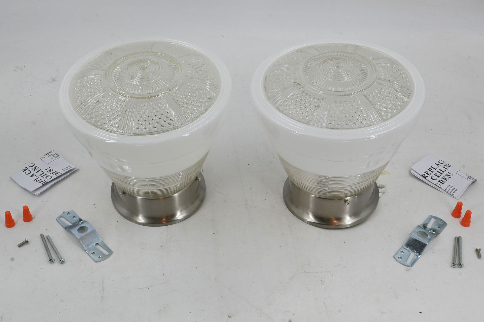 Pair of matching Mid Century Modern clear/white shades on brushed nickel fitters: Pair of matching Mid Century Modern clear/white shades on brushed nickel fitters. Condition: Age Consistent. Vintage shades on new fitters. Illumination: One medium Edison socket per fixture. Material