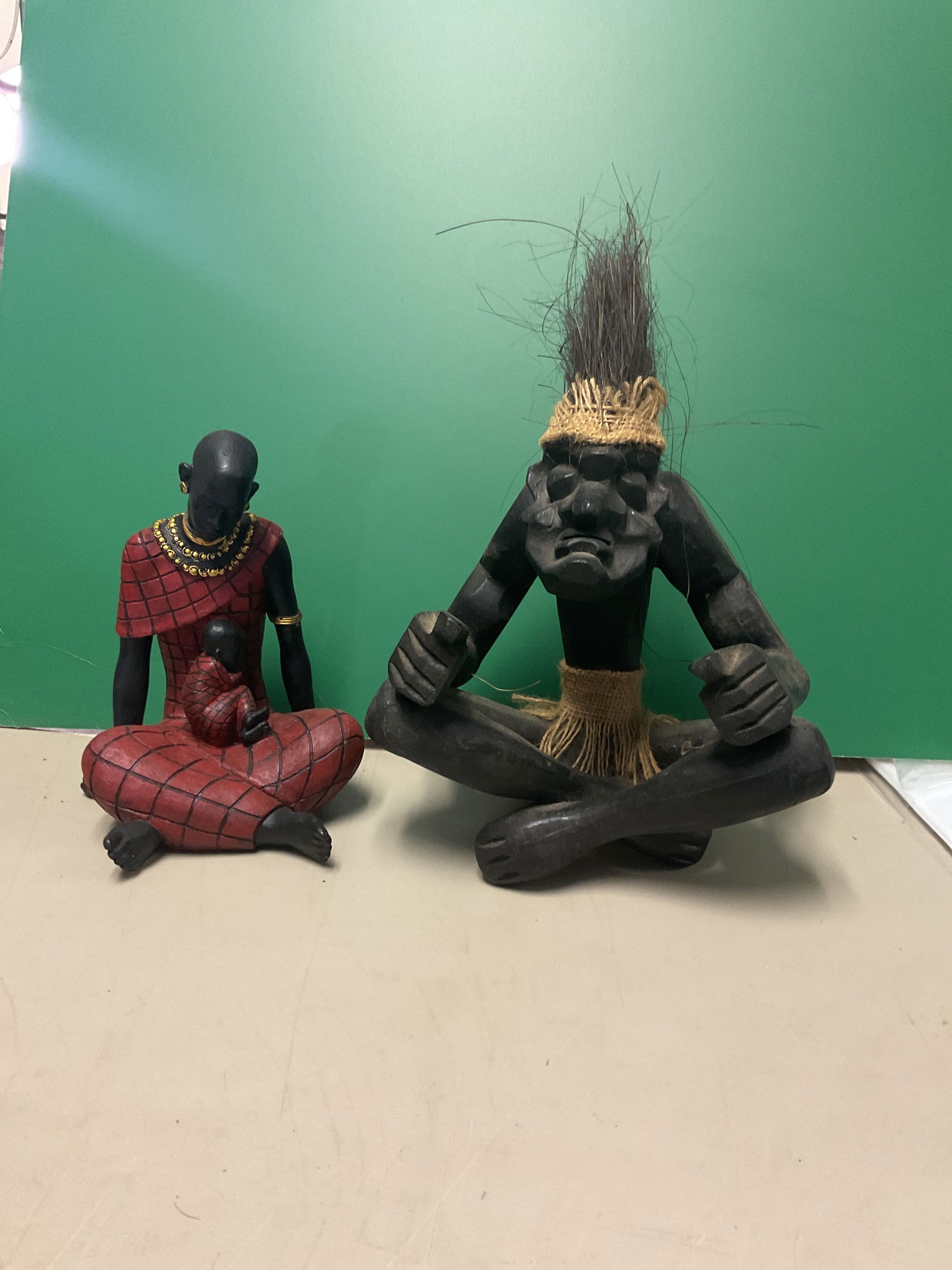 Lot of 2 African figures: Man is approx 8 inches woodFemale is a plaster type approx 6”