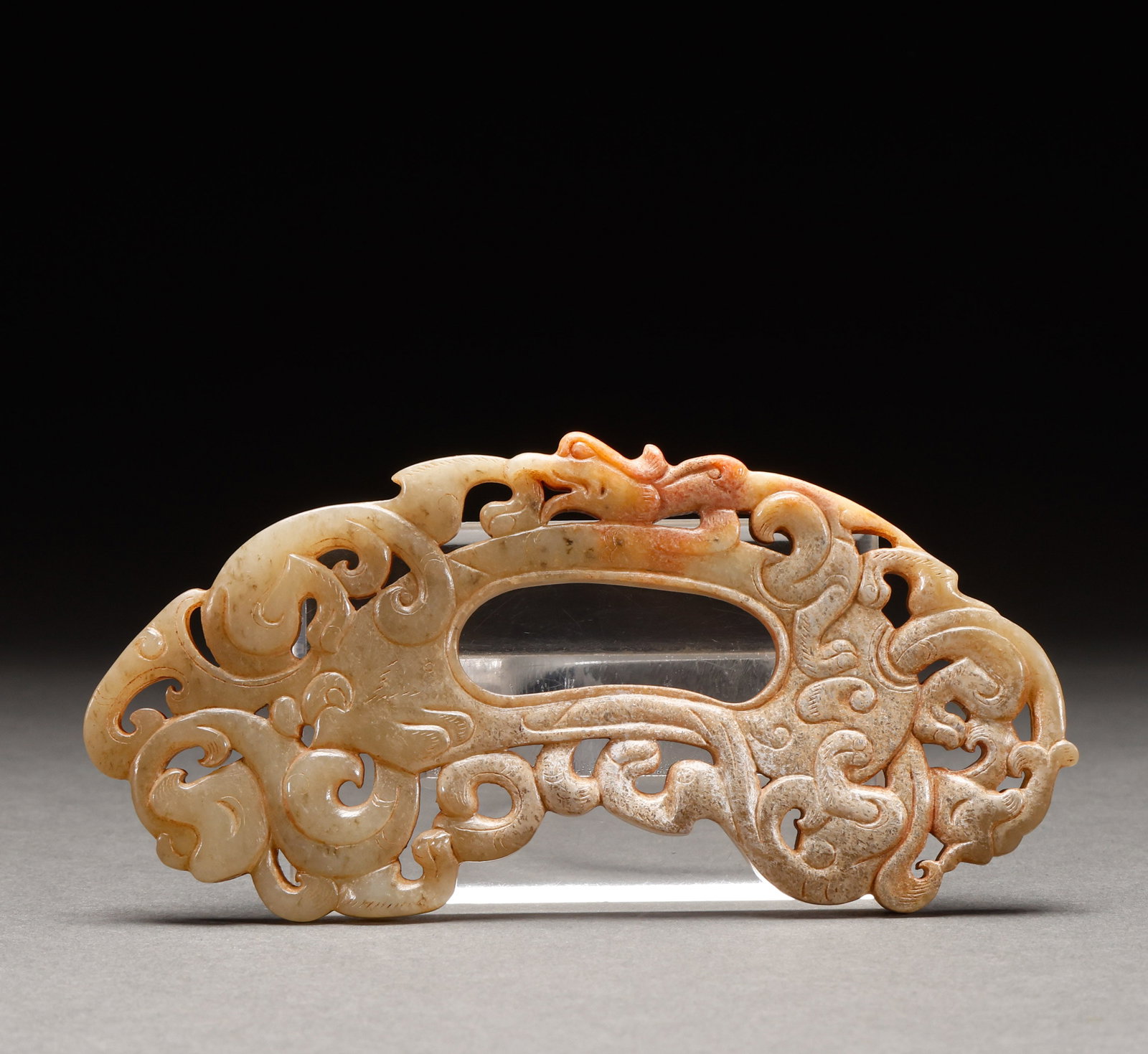 Before the Ming Dynasty, Hotan Jade was carved with dragon patterns: Weathered jade openwork dragon-pattern archer's ring pendant, weathered jade, openwork double dragon pattern, central perforation, exquisite craftsmanship. Height: 7cm, Width: 14.5cm, Weight: 127g.