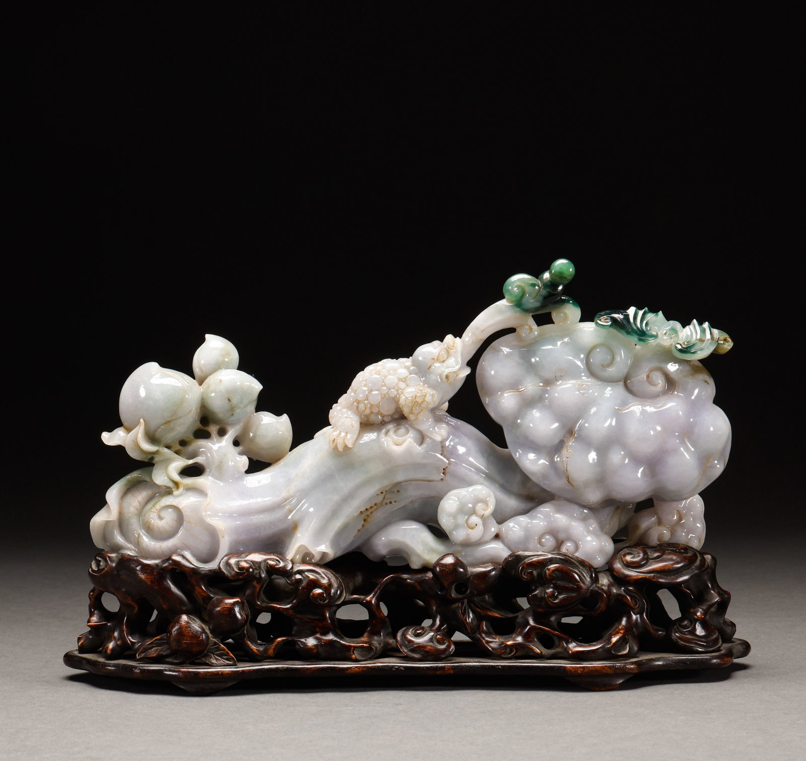 Qing Dynasty Jade Golden Toad Ruyi Ornament: Jadeite golden-toad ruyi ornament, jadeite, cleverly carved golden toad, lingzhi mushroom and longevity peach, symbolizing auspiciousness, with Hongmu wood stand. Height: 17cm, Width: 27cm, Weight: 19