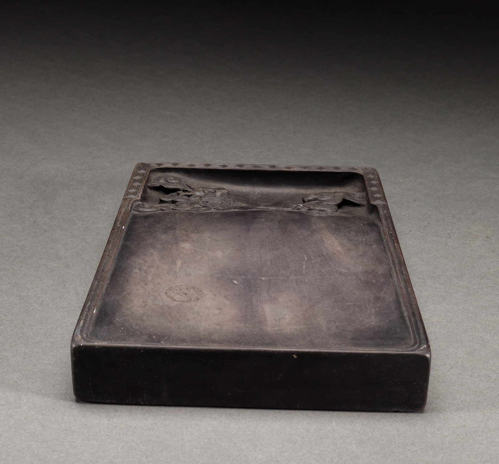 Duan Shi Inkstone: Duan stone inkstone, Duan stone material, cloud-pattern ink pool carved on the surface, fine stone texture with natural stone eye, well-formed. Length: 21.5cm, Width: 15cm, Weight: 2049g.