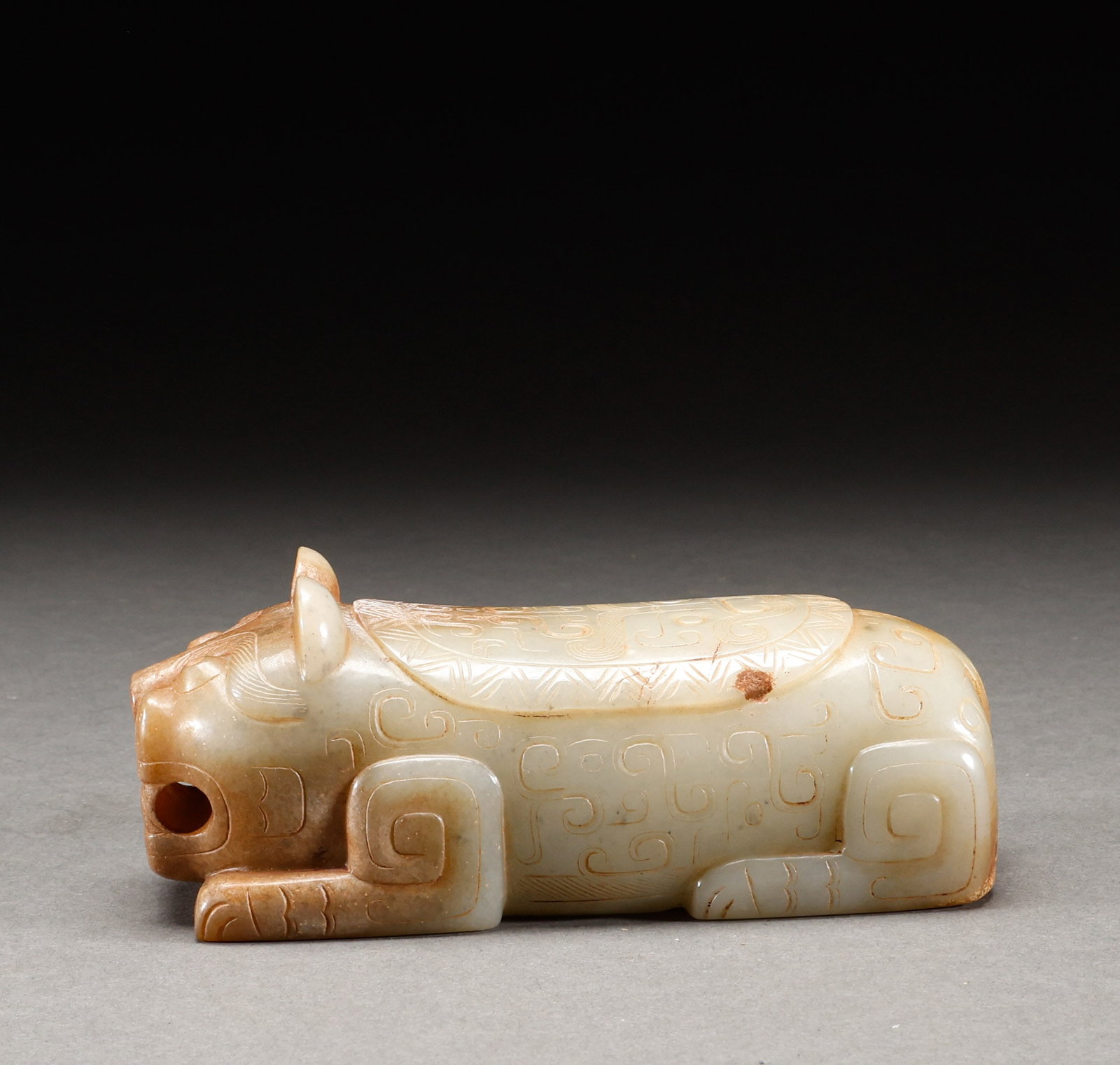 Before the Ming Dynasty, the blue and white jade was subjected to the Qin lying tiger handle: Greenish-white jade weathered reclining tiger hand piece, warm and lustrous jade with natural patina, body decorated with key-fret pattern, ancient carving style. Height: 4.5cm, Width: 13.5cm, Weight: