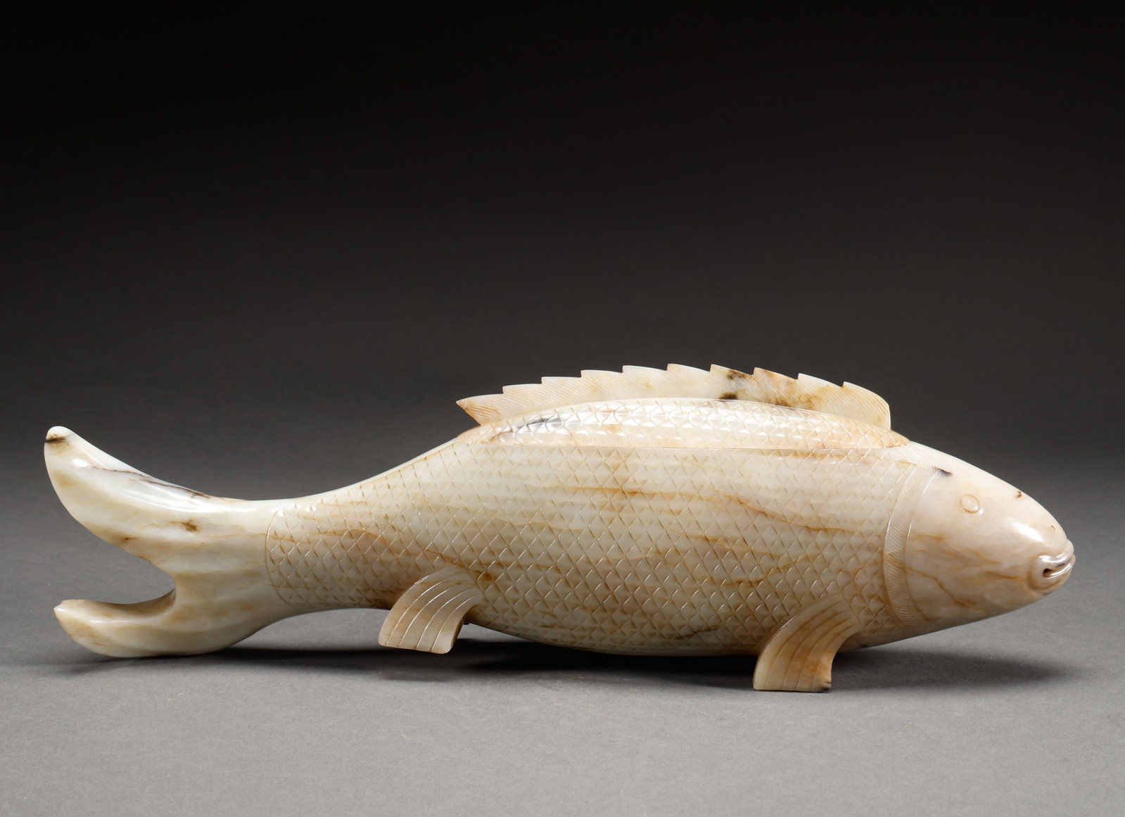 Qing Dynasty Hotan Jade Fish shaped Cap Jar: Qing Dynasty Hetian jade fish-shaped covered jar, white Hetian jade carved fish-shaped covered jar, scale pattern carved on body, vivid form, warm and lustrous jade. Height: 13cm, Width: 39.5cm, Weigh