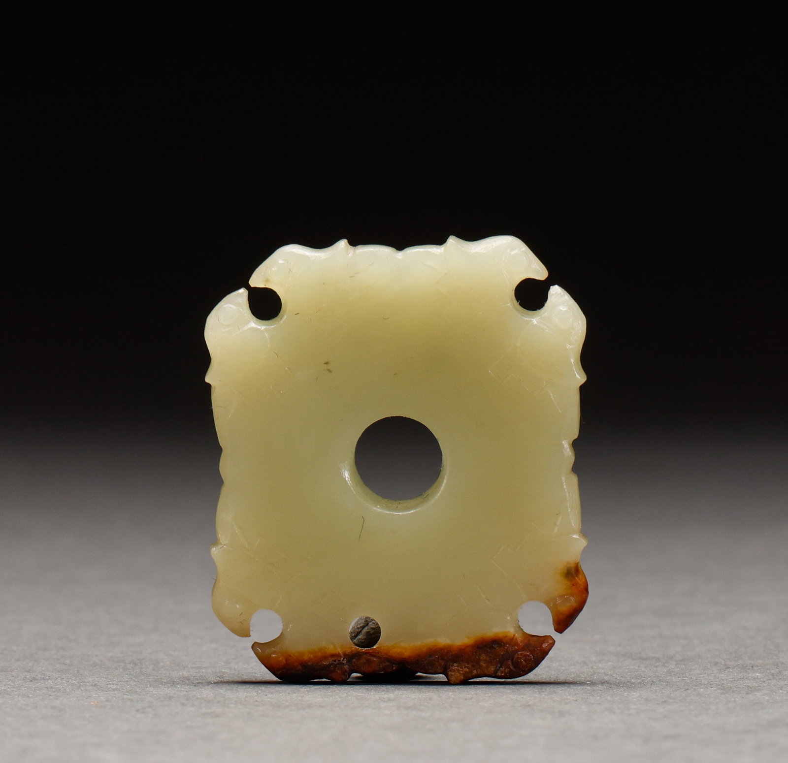 Before the Ming Dynasty, Hetian Huangyu carved out square jade: Yellow jade openwork square bi disc, yellow jade, square form with extended outline, perforations at four corners, red patina at bottom. Height: 4.2cm, Width: 3.7cm, Weight: 18g.