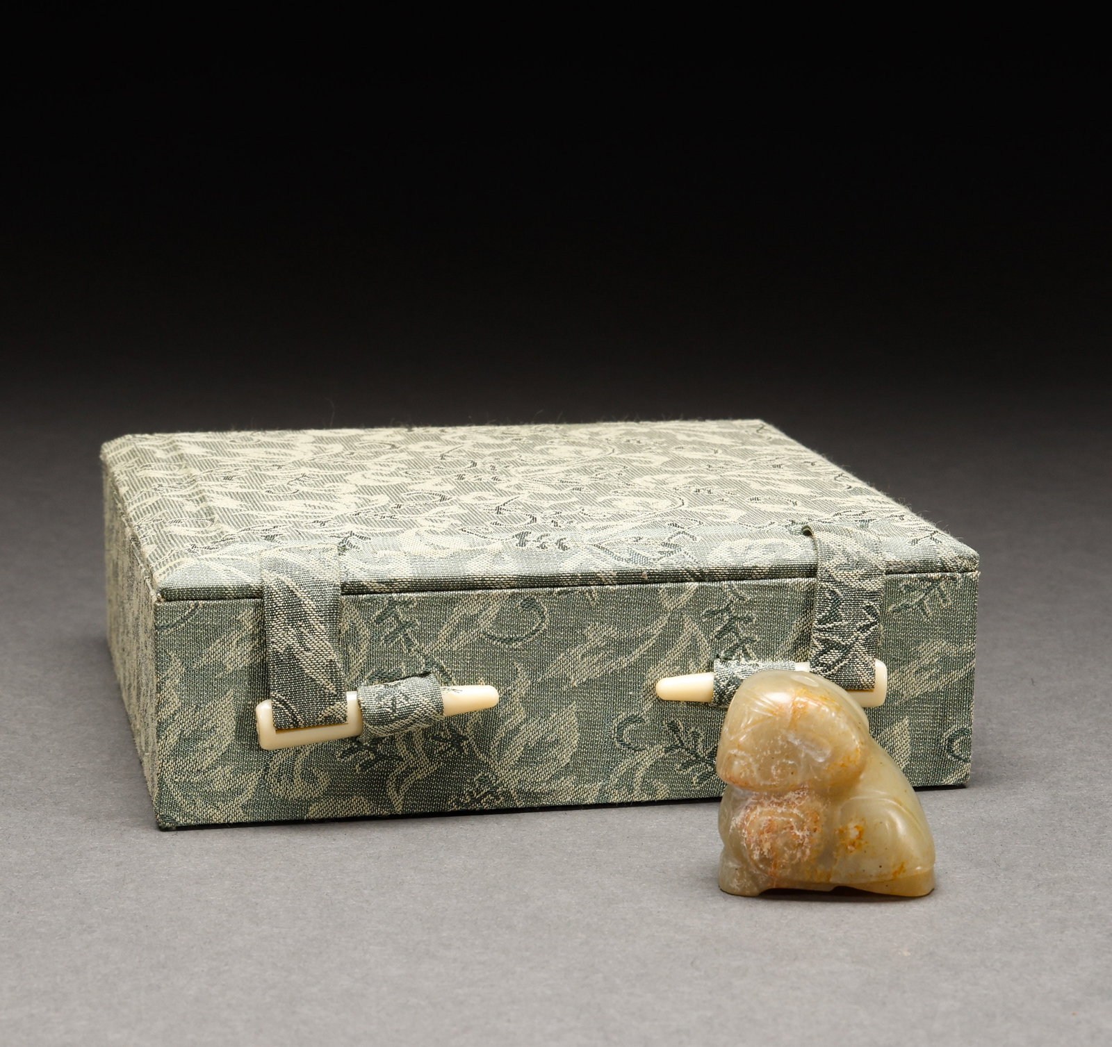 Before the Ming Dynasty, Hotan Jade was immersed in sheep shaped handpieces: Weathered jade sheep-form hand piece, weathered jade, sheep body reclining, charming and naive form, with old brocade box. Height: 3.3cm, Width: 3.3cm, Weight: 47g.