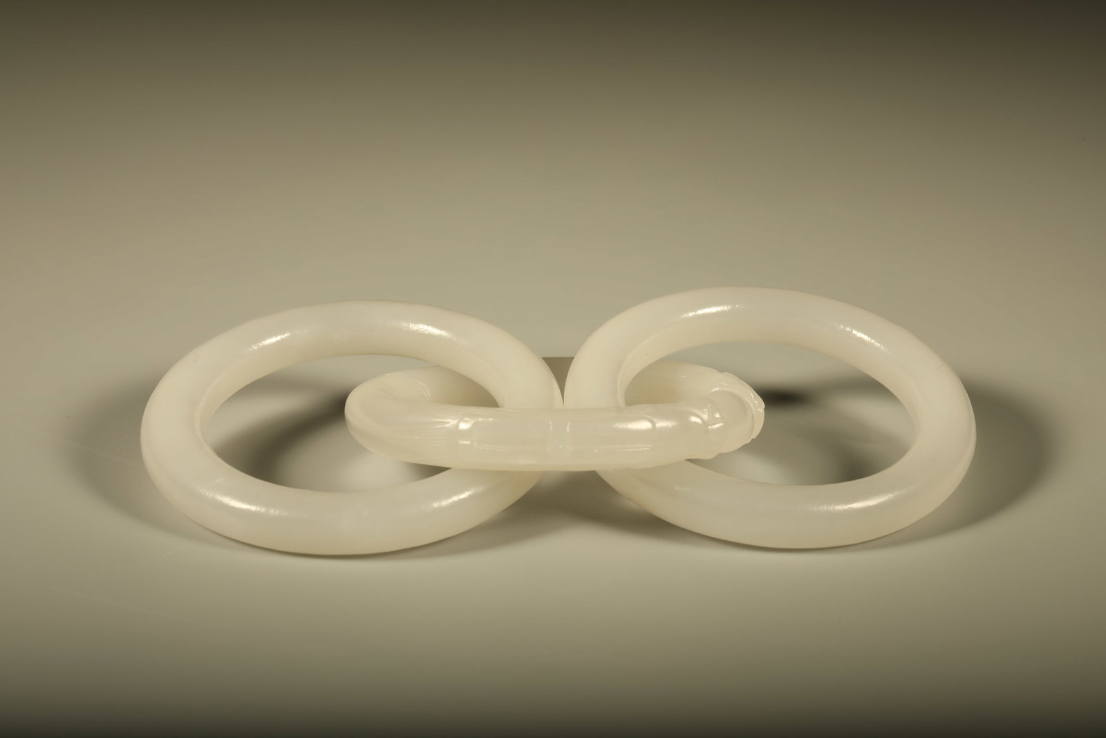Hetian Jade Carving of the Qing Dynasty with two dragons playing with pearls: Hetian jade carved two-dragons-playing-pearl interlocking rings, warm and lustrous jade, round and full, symbolizing peace. Dimensions: Diameter: 5.3cm.