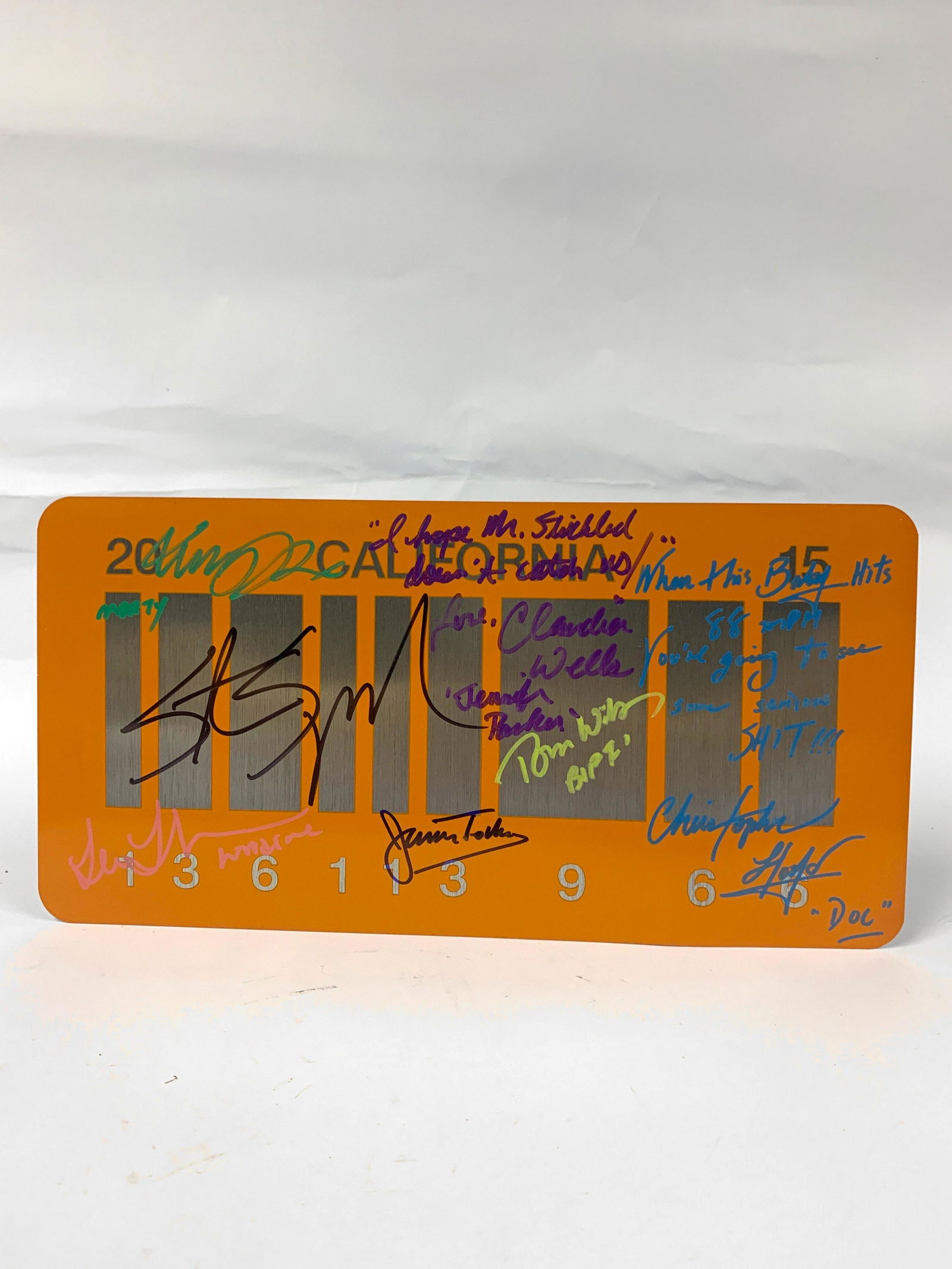 Autograph Back to Future Carplate: Autograph Includes: Michael J Fox, Christopher Llyod, Lea Thompson, Crispin Glover, Thomas F Wilson, Claudia Wells, Billy Zane, James Tolkan, Marc McClure, Huey Lewis, Robert Zemeckis, Steven Spielber