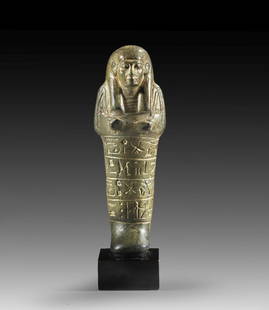 Uschebti des Pa-Ra-nacht.: Shabti of Pa-ra-nacht. New Kingdom, 20th dynasty, time of Ramses IV. or Ramses V., ca. 1152 - 1142 BC. Basalt, H 13cm. Mummy-shaped with tripartite wig and ploughs in the crossed hands. A net-like