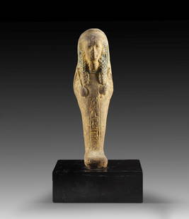 Uschebti des Nes-Amun-jpet.: Shabti of Nes-Amun-jpet. New Kingdom, 21st dynasty, ca. 1000 BC. Red clay, rests of blue colour. H 19.2cm. Found in 1891 in Deir el-Bahari, Cachette II. Mummy-shaped with plastically curled wig and