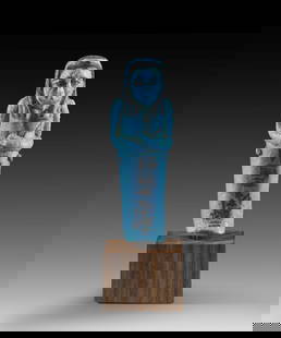 Uschebti des Pasen.: Shabti of Pasen. New Kingdom, 20th dynasty, reign of Ramses IX., ca. 1127-1109 BC. Blue faience, details in black colour. H 9.8cm. Mummy-shaped with tripartite wig, plough and seed bag. The