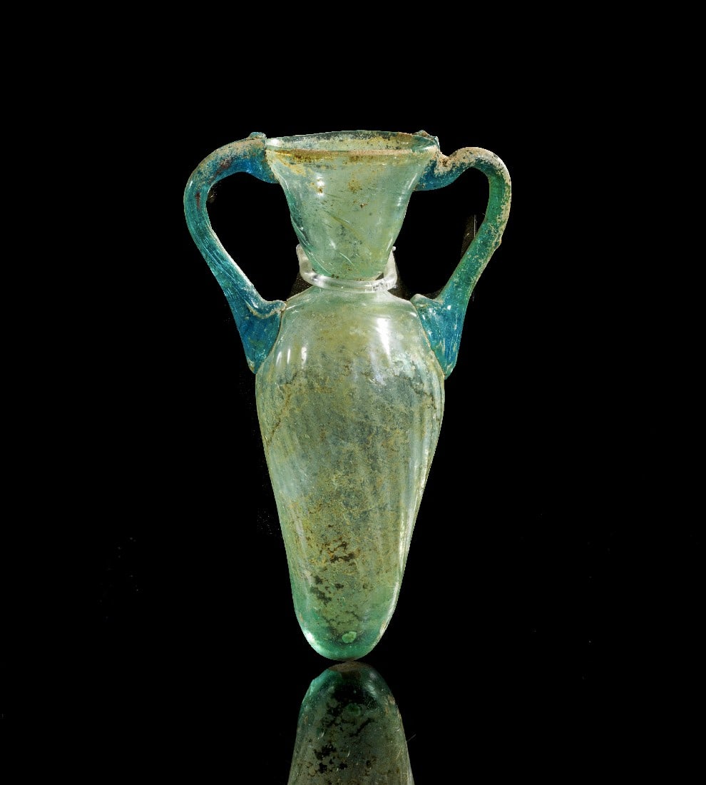 Amphoriskos.: Amphoriskos. Eastern Mediterranean, 4th - 5th c. AD. H 13cm. Green and blue translucent glass. Conical body with handles, rounded shoulder, slim neck and broad rim. Rests of iridescence, intact and wi