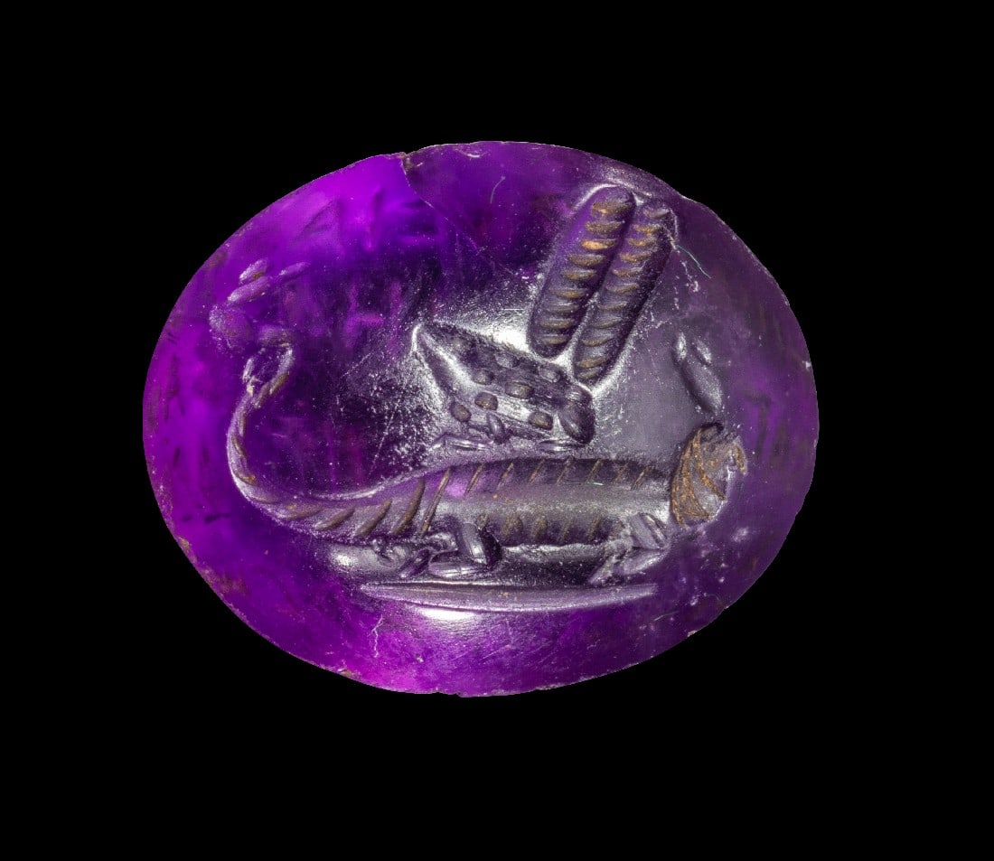 Magische Gemme aus Amethyst.: Magische Gemme aus Amethyst. Römische Kaiserzeit, ca. 2. Jh. n. Chr. 1,9 x 1,5cm. Ovaler, beidseitig konvexer Stein. Auf einer Seite ein Mischwesen bestehend aus Krokodilskörper mit Geierkopf und
