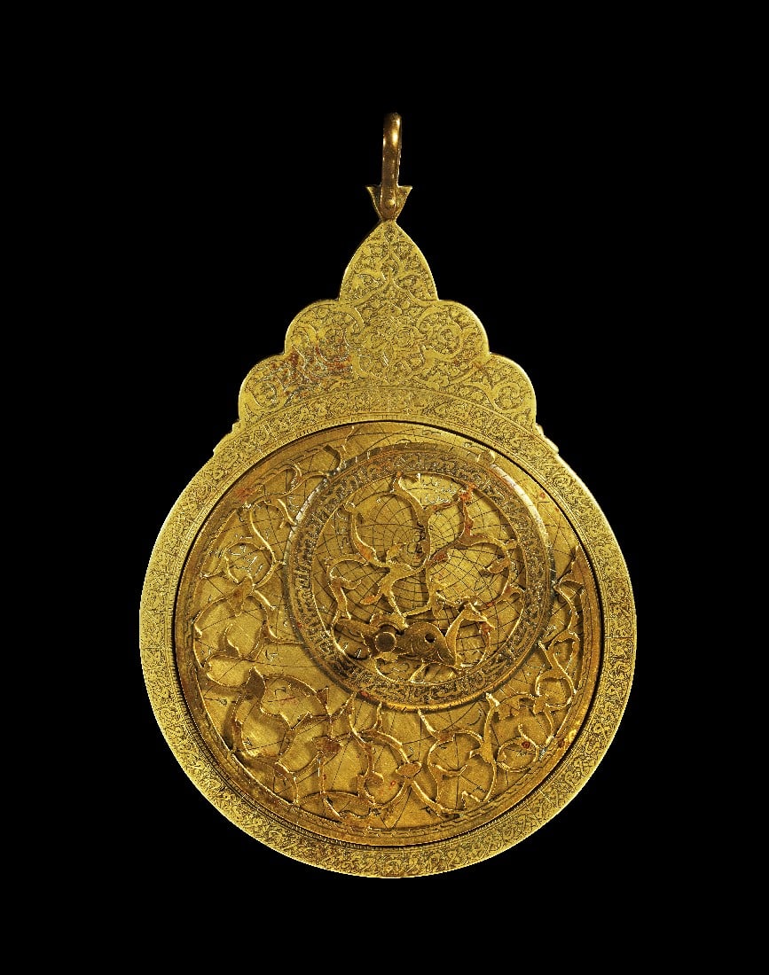 Dekoratives Astrolabium.: Dekoratives Astrolabium. Persien, um 18. - 19. Jh. H 18,7cm, B 12,2cm. Messing, Details in Kaltarbeit. Inschriften auf Farsi. Mater reich beschriftet, mit Arabeskenthron und kleiner dreilappiger