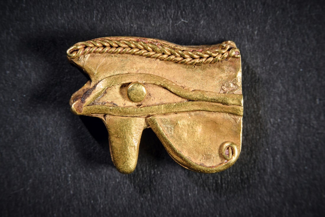 Goldenes Amulett in Form eines Udjat-Auges.: Goldenes Amulett in Form eines Udjat-Auges. Spaetzeit, 1. Jt. v. Chr. 1,22g, B 1,5cm, H 1,2cm. Aus Goldfolie, beidseitig gestaltet, mit Laengsbohrung. Urspruenglich Element einer Kette. Gold! Intakt.