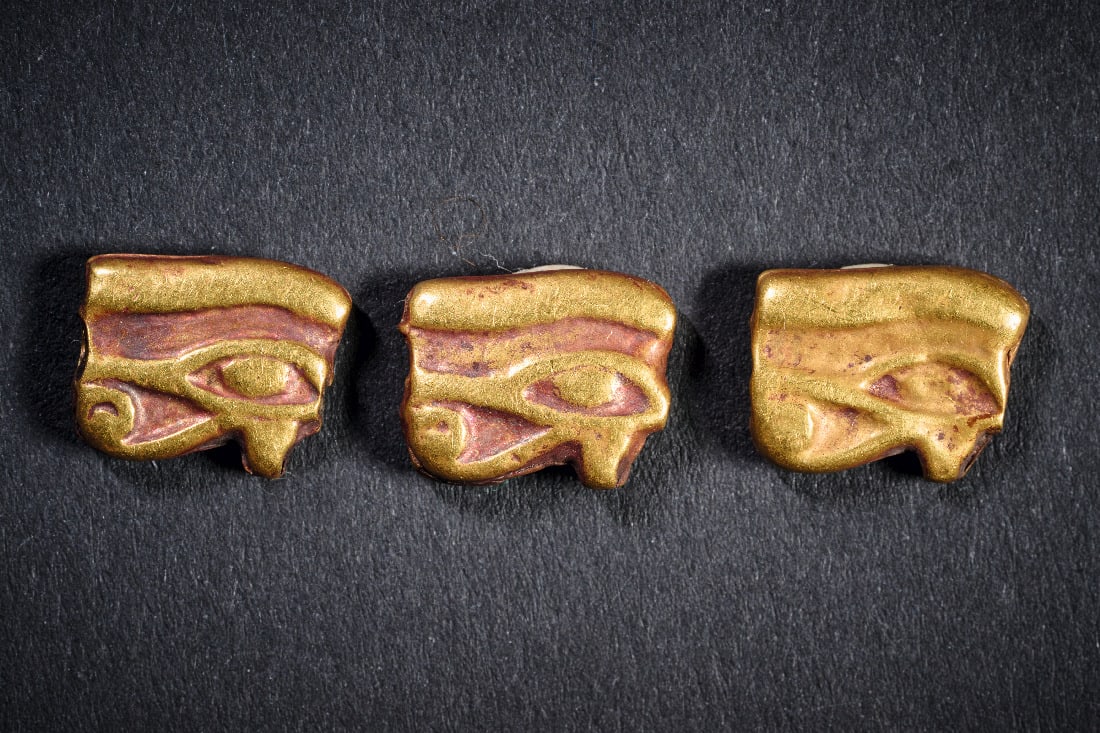 Drei goldene Udjat-Augen.: Drei goldene Udjat-Augen. Neues Reich, 1550 - 1070 v. Chr. 6,75g, B 1,1cm. Aus Goldblech, mit Laengsbohrung. Elemente eine Kette. 3 Stueck! Gold! Intakt. Provenienz: Erworben bei Sotheby's London,