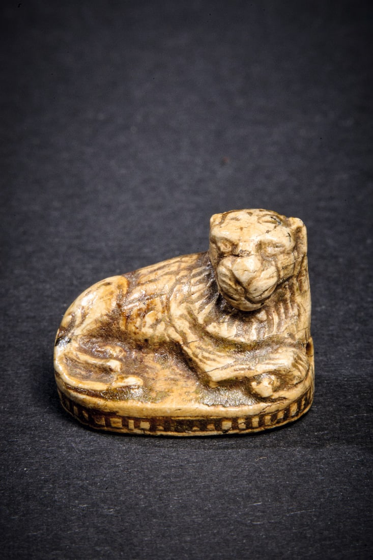 Siegel in Loewenform.: Siegel in Loewenform. Neues Reich, 1550 - 1070 v. Chr. B 2cm. Aus glasiertem Steatit. Liegender Loewe mit Laengsbohrung auf einer hochovalen Platte. Auf der Unterseite Hieroglyphen mit der Bedeutung