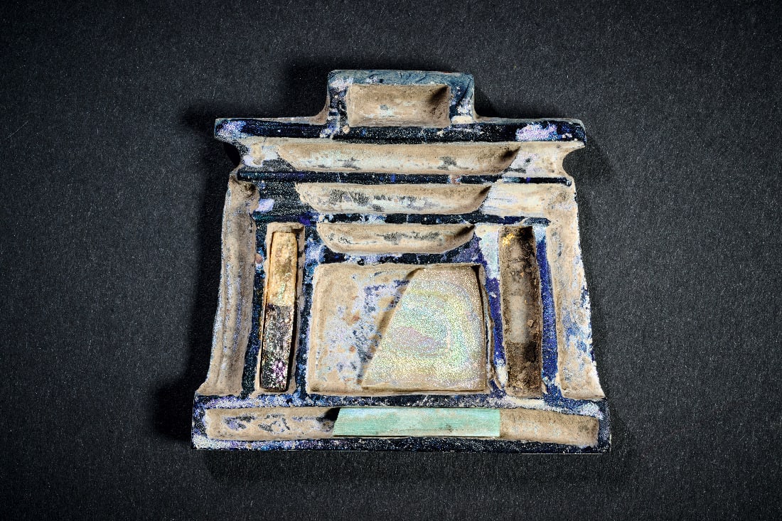 Naos-Pektoral.: Naos-Pektoral. Ptolemaeerzeit, ca. 323 - 30 v. Chr. H 5,5cm B 6cm. Glasamulett in Form eines Schreins mit eingelegten andersfarbigen Glaesern, teils vergoldet. Eingelegte Glaeser fehlen teils.