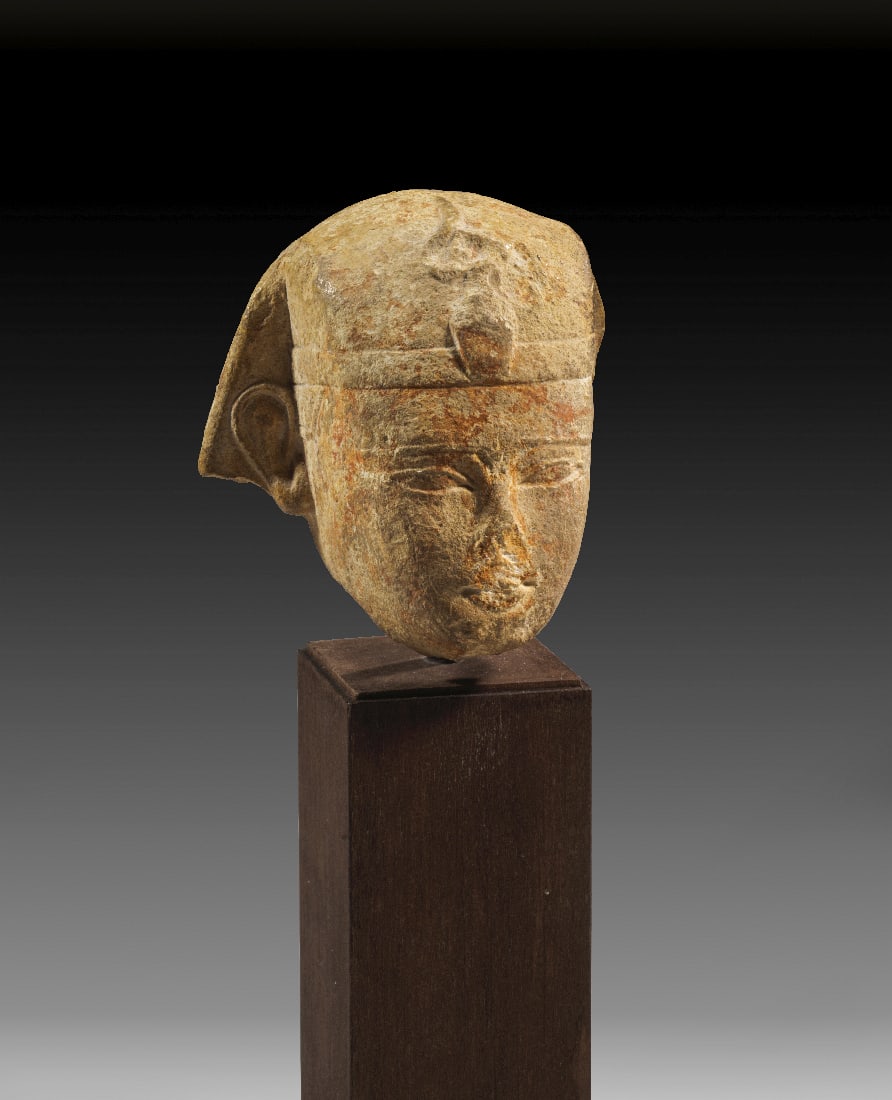 Kopf eines Pharaos aus Kalkstein.: Kopf eines Pharaos aus Kalkstein. Ptolemaeisch, 4. - 3. Jh. v. Chr. H 12,5cm (mit Sockel), H 5,5cm (ohne Sockel). Mit Nemesis-Kopftuch und Uraeus-Schlange ueber der Stirn. Oberflaeche berieben, im