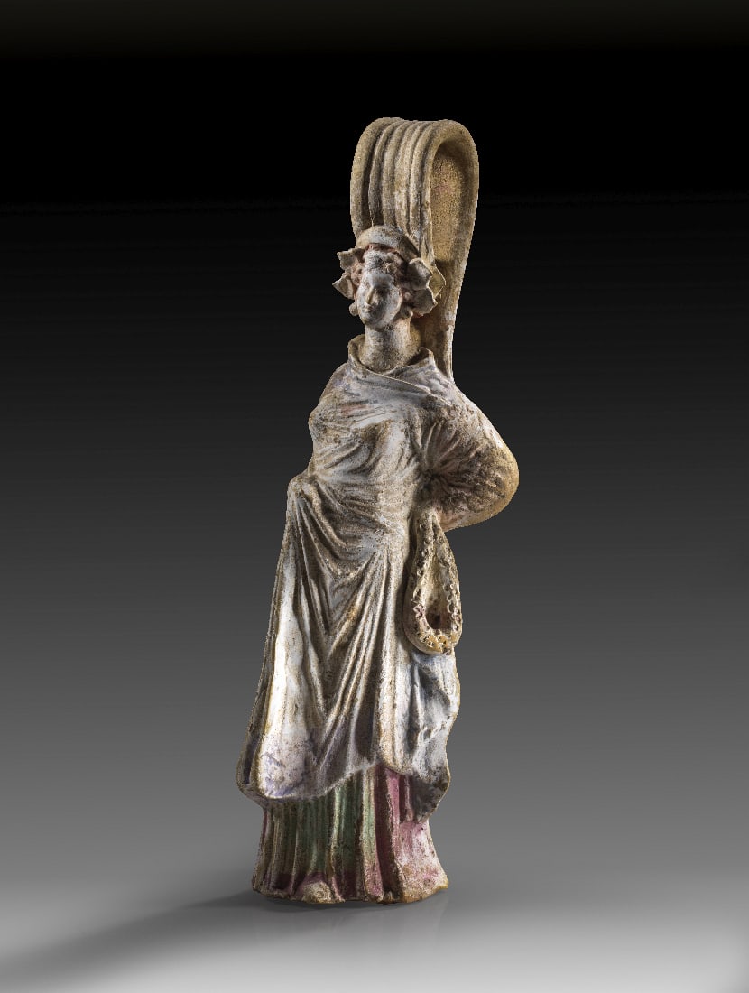 Pseudo-Gefaess mit Frauenfigur.: Pseudo-Gefaess mit Frauenfigur. Canosa, 3. Jh. v. Chr. H 30cm, B 8,5cm. Aus beigem Ton mit Resten von weisser Engobe und Bemalung in hell- und dunkelrosa, violett, gruen und braun. Rueckwaertig ein