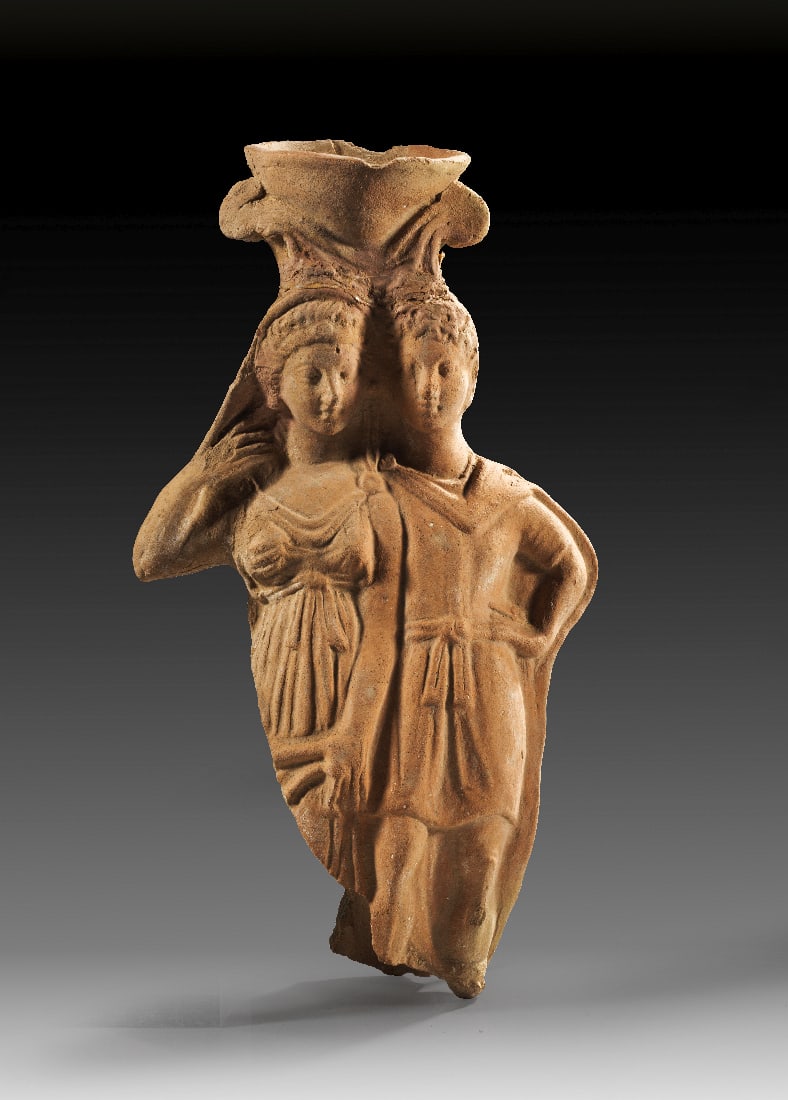 Figurales Thymiaterion mit Paar.: Figurales Thymiaterion mit Paar. 2. Jh. v. Chr. - 1. Jh. n. Chr. H erhalten 29,2cm. Hellbrauner Ton, rueckwaertig Brennloch. Weihrauchstaender in Gestalt eines jungen Paares. Sie ist durch einen