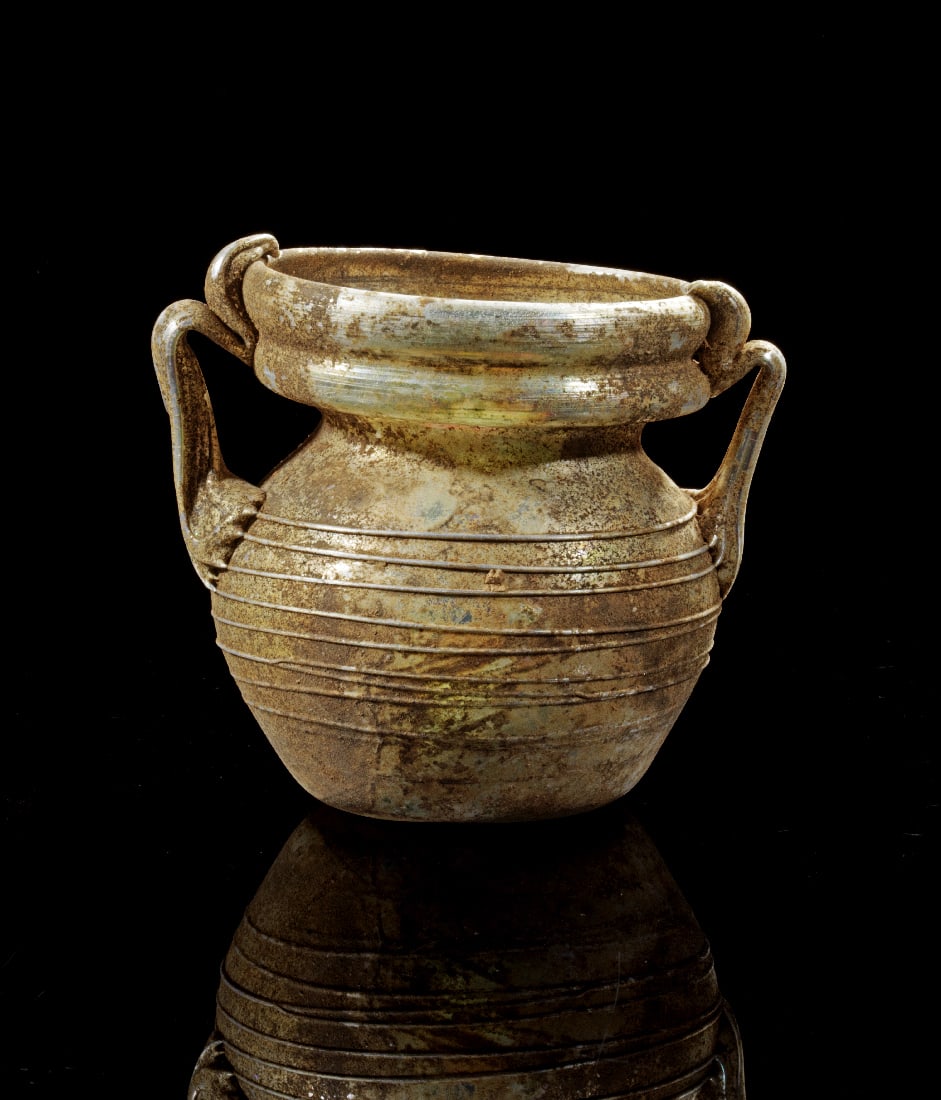 Zweihenkeliges Toepfchen mit feinem Fadendekor.: Zweihenkeliges Toepfchen mit feinem Fadendekor. oestlicher Mittelmeerraum, ca. 3. - 4. Jh. n. Chr. H 8cm. Klarglas. Ovoider Corpus mit eingezogenem Hals und weiter, zweifach geschwungener Lippe. Auf