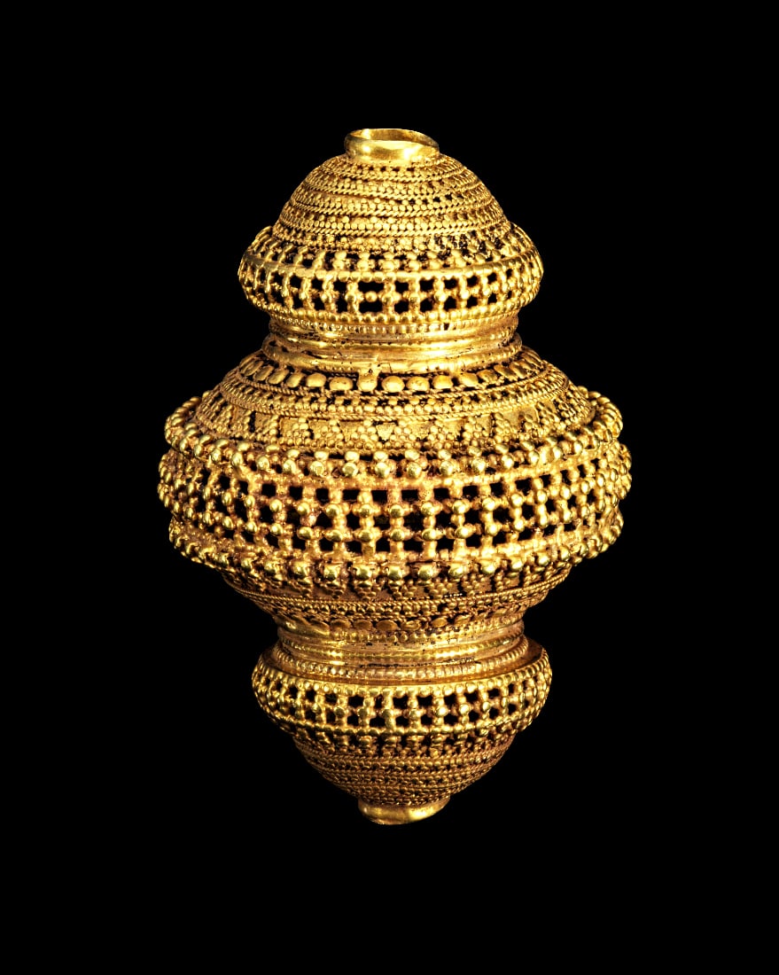 Grosse Goldperle mit Granulatdekor.: Grosse Goldperle mit Granulatdekor. Indien, Gujarat, fruehes 20. Jh. 68,40g, L 6,3cm. 21 Karat. Profilierte, dreigeteilte Perle mit durchbrochen gearbeiteten Bereichen und Granulatdekor. Publiziert!
