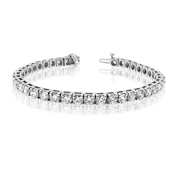 3.00 ct. Round Diamond Tennis Bracelet 14k White Gold: This 7.0 inch Round Diamonds tennis bracelet is in 14k White Gold. 5.64 Grams. The diamonds are set in a four prong setting and have a clarity of SI-1/SI-2.Color G-H. This bracelet has has a Double sa