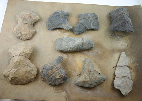 AACA Nine assorted Stone items found in Northern A: AACA Nine assorted Stone items found in Northern Arkansas. Wired to original board. Artifacts include seven Flint Hoes, one Knife, and one Celt.