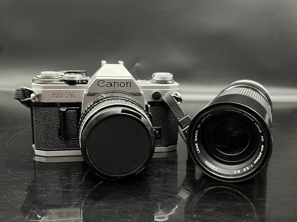 Canon AE-1 w/ Canon Zoom 100-200mm f/5.6: See title and images for a description on this item.