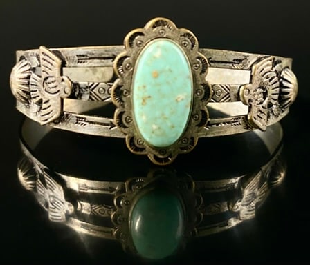 Navajo Turquoise & Bird Motif Cuff Bracelet: Thunderbird Motif, non precious metal, Measures: 2 1/2" at its widest opening. Total Size: 3" x 2" x 1"