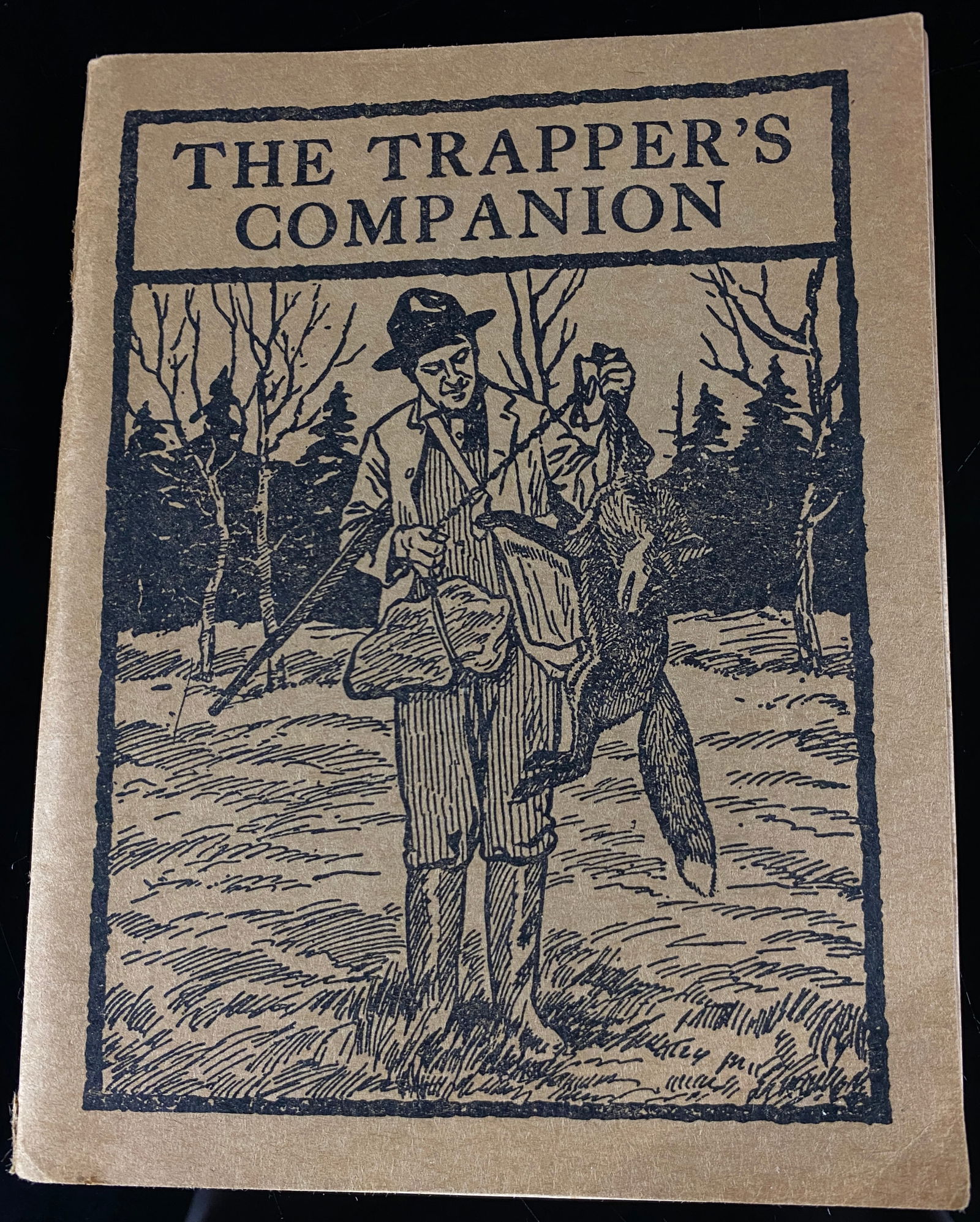 The Trapper's Companion, 1946 Revised Edition, Fur-Fish-Game, Columbus, Ohio: A vintage softcover manual titled "The Trapper's Companion," identified as a 1946 Revised Edition. Published by FUR-FISH-GAME of Columbus, Ohio, the manual features a tan cardstock cover with a black