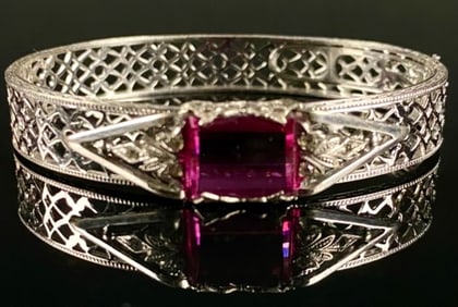 A Sterling Silver Rhodium Plated Art Deco Filigree Bangle Bracelet with Magenta Glass Stone