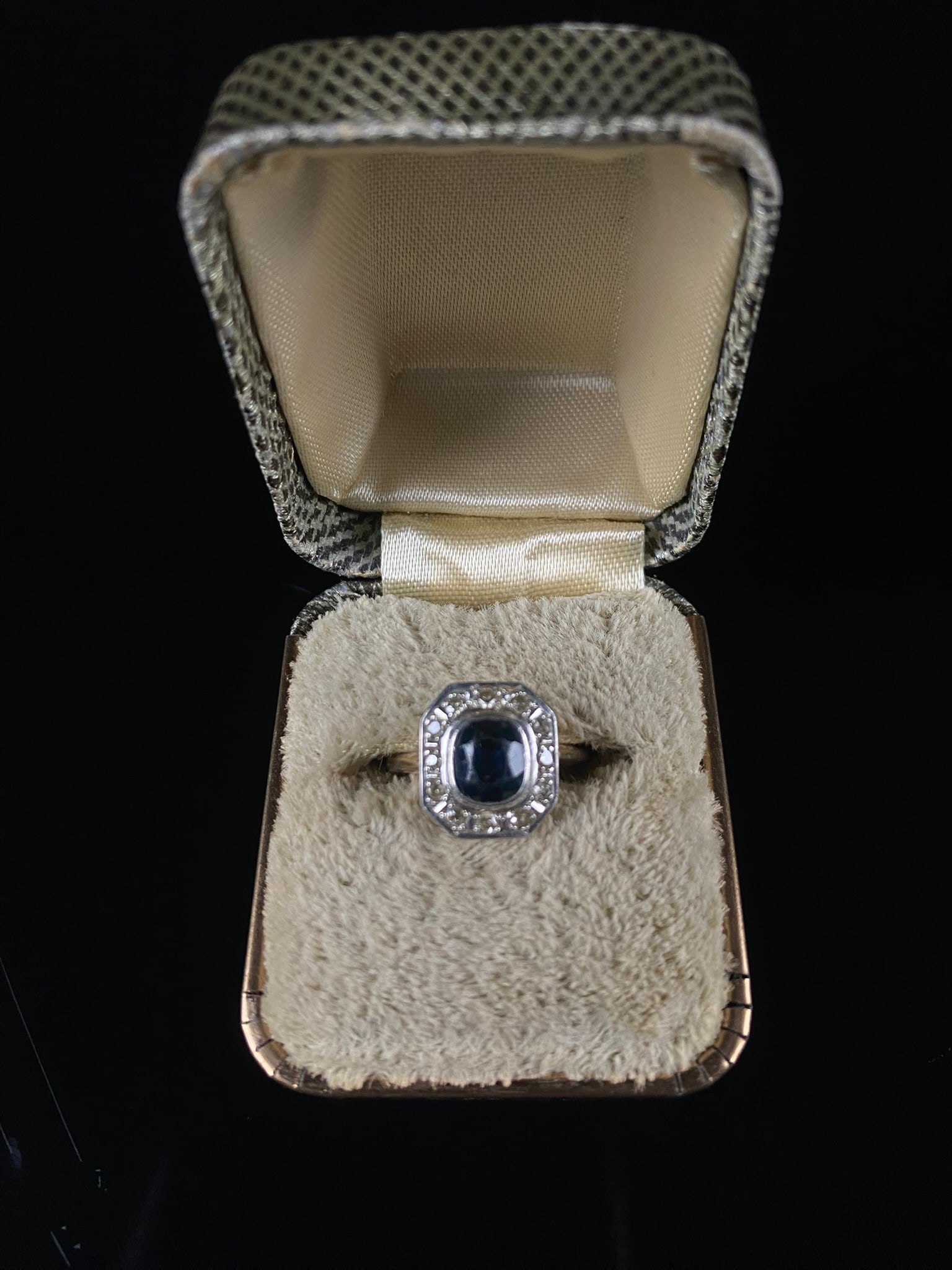 Art Deco 14K Yellow Gold Sapphire and Diamond Ring: An Art Deco finger ring crafted from 14K yellow gold, clearly stamped "14K" on the interior of the band. The ring features an octagonal halo design, centered with a bezel-set , surrounded by a border