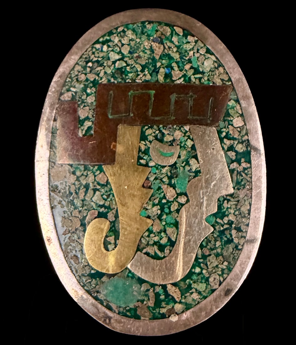 Taxco Sterling Silver 'SH' Inlaid Metales Casados Abstract Brooch Pendant: A Taxco sterling silver 'SH' inlaid metales casados brooch pendant. This oval-shaped pendant-brooch features a vibrant mosaic inlay of crushed green stone, likely malachite or turquoise. The central d