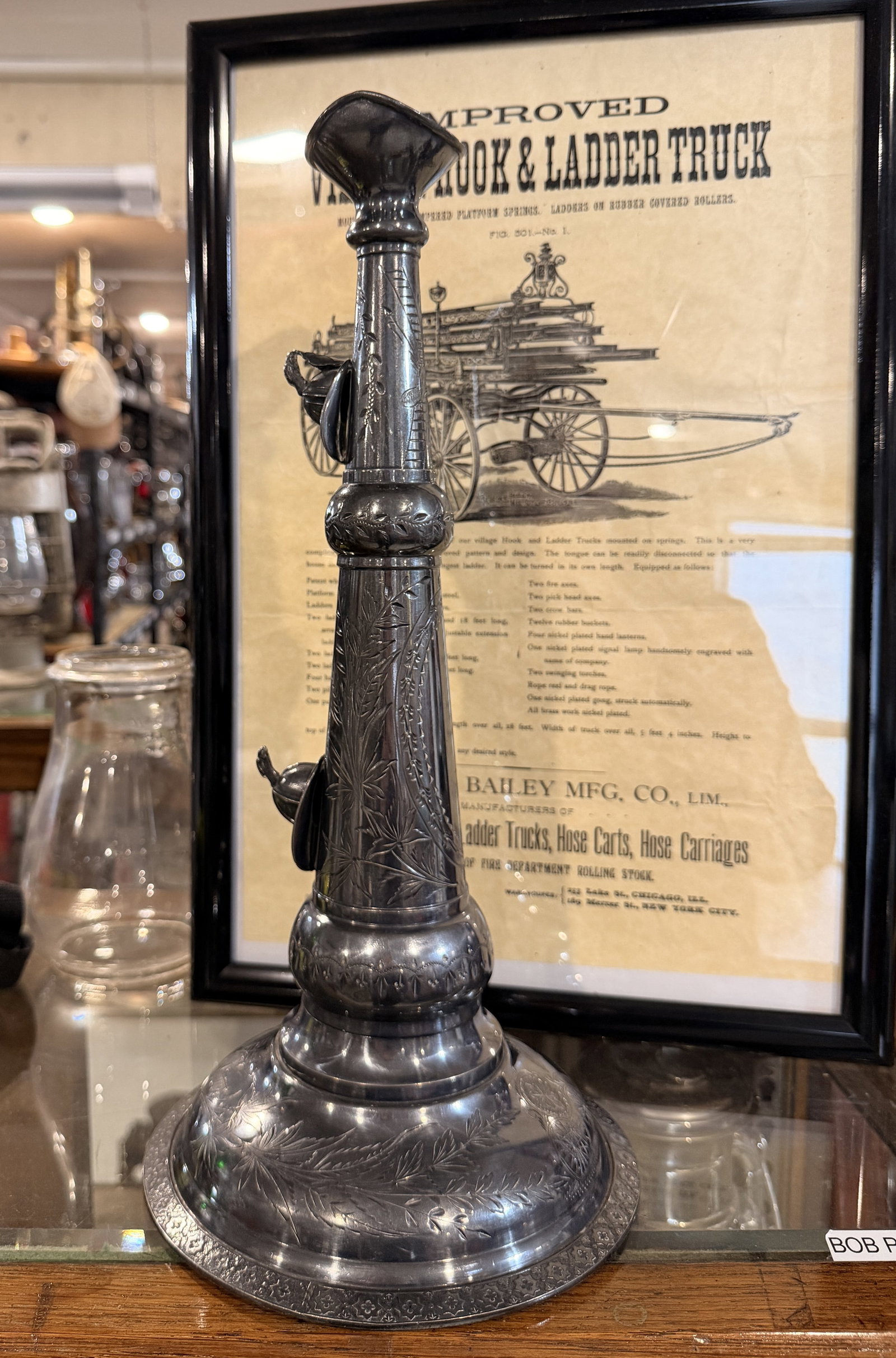 Fred Miller 19th High Eagle Fireman's Speaking Trumpet: A late 19th to early 20th-century silver-plated fireman's speaking trumpet, featuring a flared base and top with an open, hollow interior. The column and base are extensively decorated with engraved