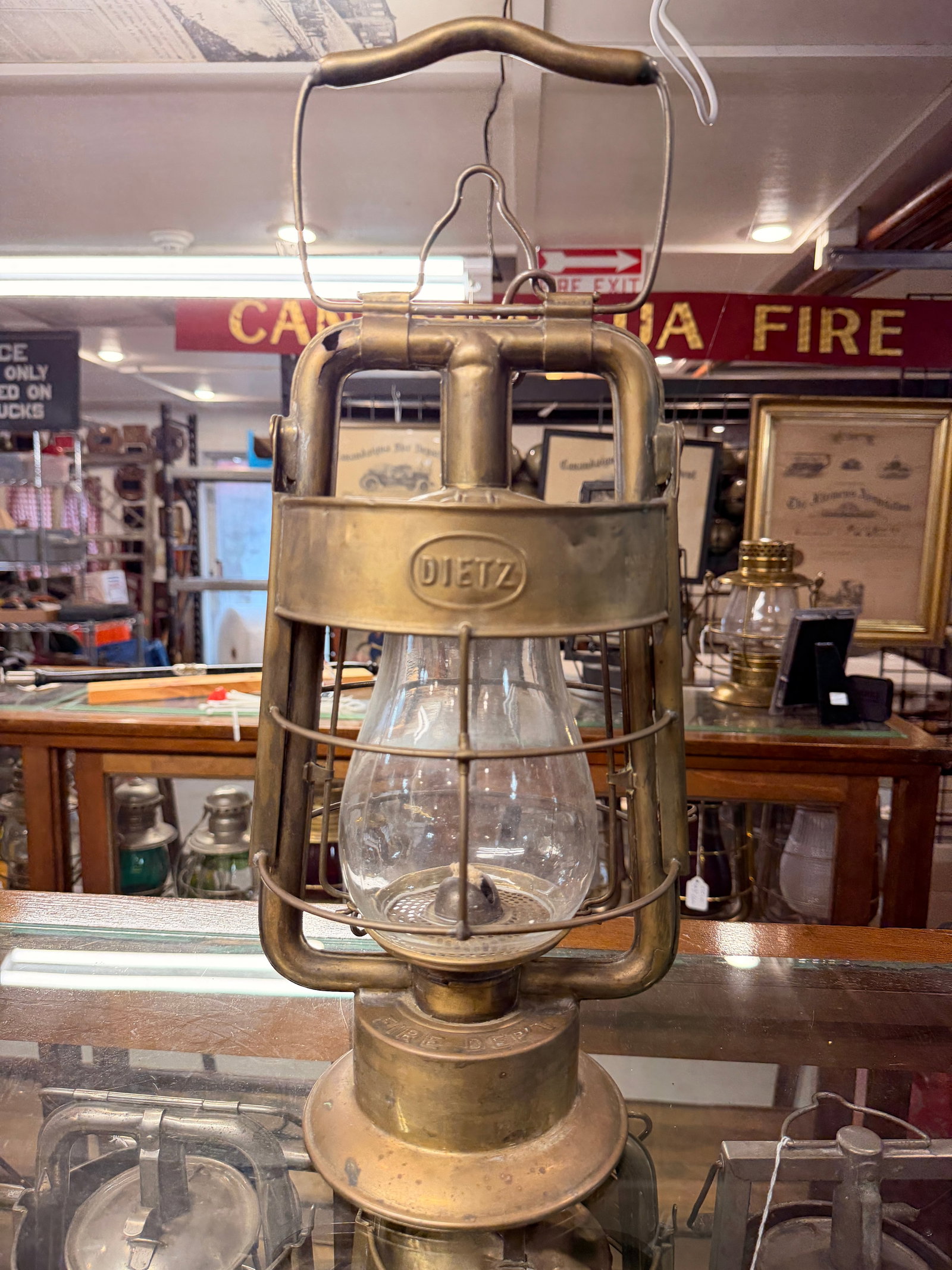 Antique Dietz 'King' Fire Department Brass Oil Lantern: An antique Dietz 'King' Fire Department brass oil lantern, featuring a utilitarian design characteristic of the early to mid-20th century. The brass-bodied lantern is prominently marked "DIETZ" on the