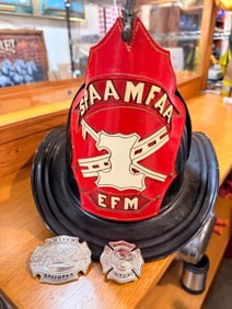 A SPAAMFAA High Front Fire Helmet with Running Fireman Finial and Two Commemorative Badges