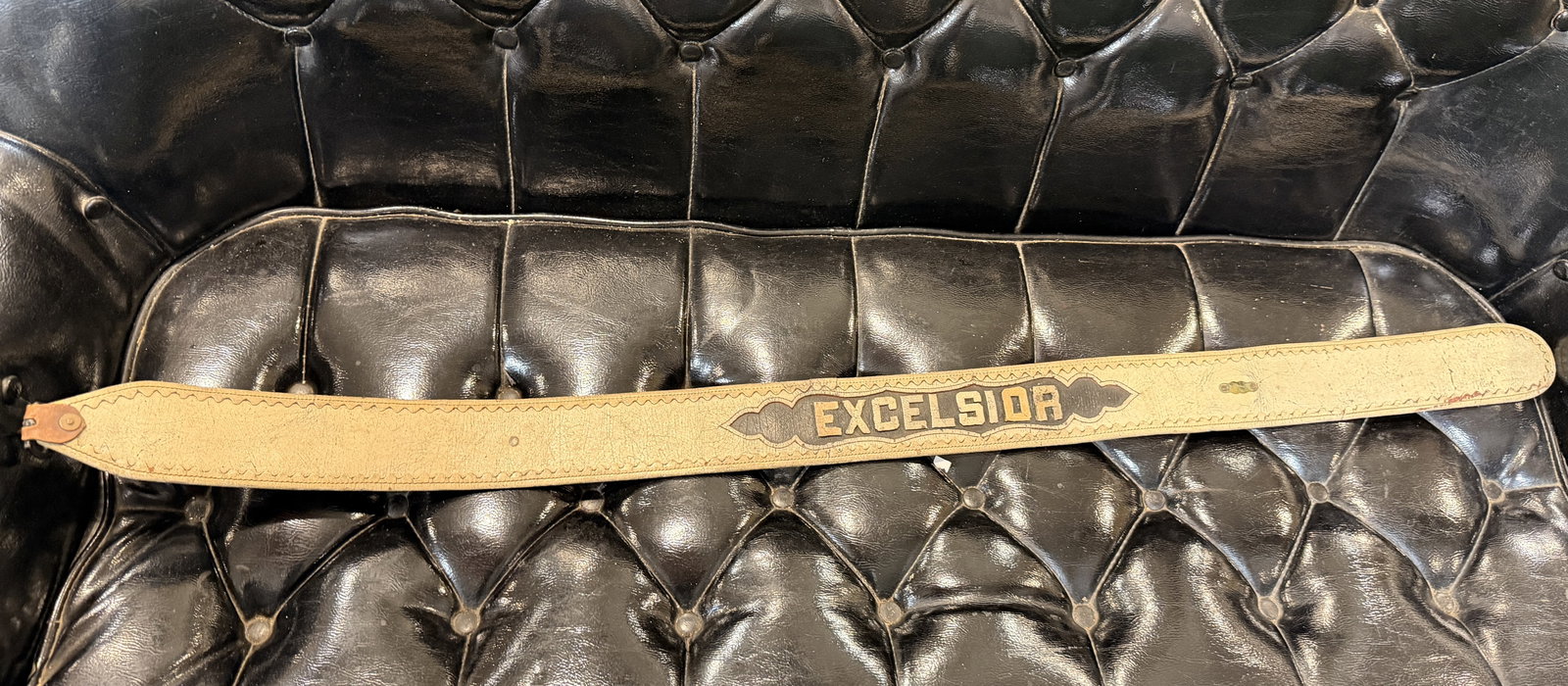 Vintage 'EXCELSIOR' Embossed Leather Strap Cairns Bros.: A vintage, medium-width leather strap, featuring a lighter-colored, heavily cracked and patinated front surface. The strap is prominently embossed with the word "EXCELSIOR" in decorative, raised lette