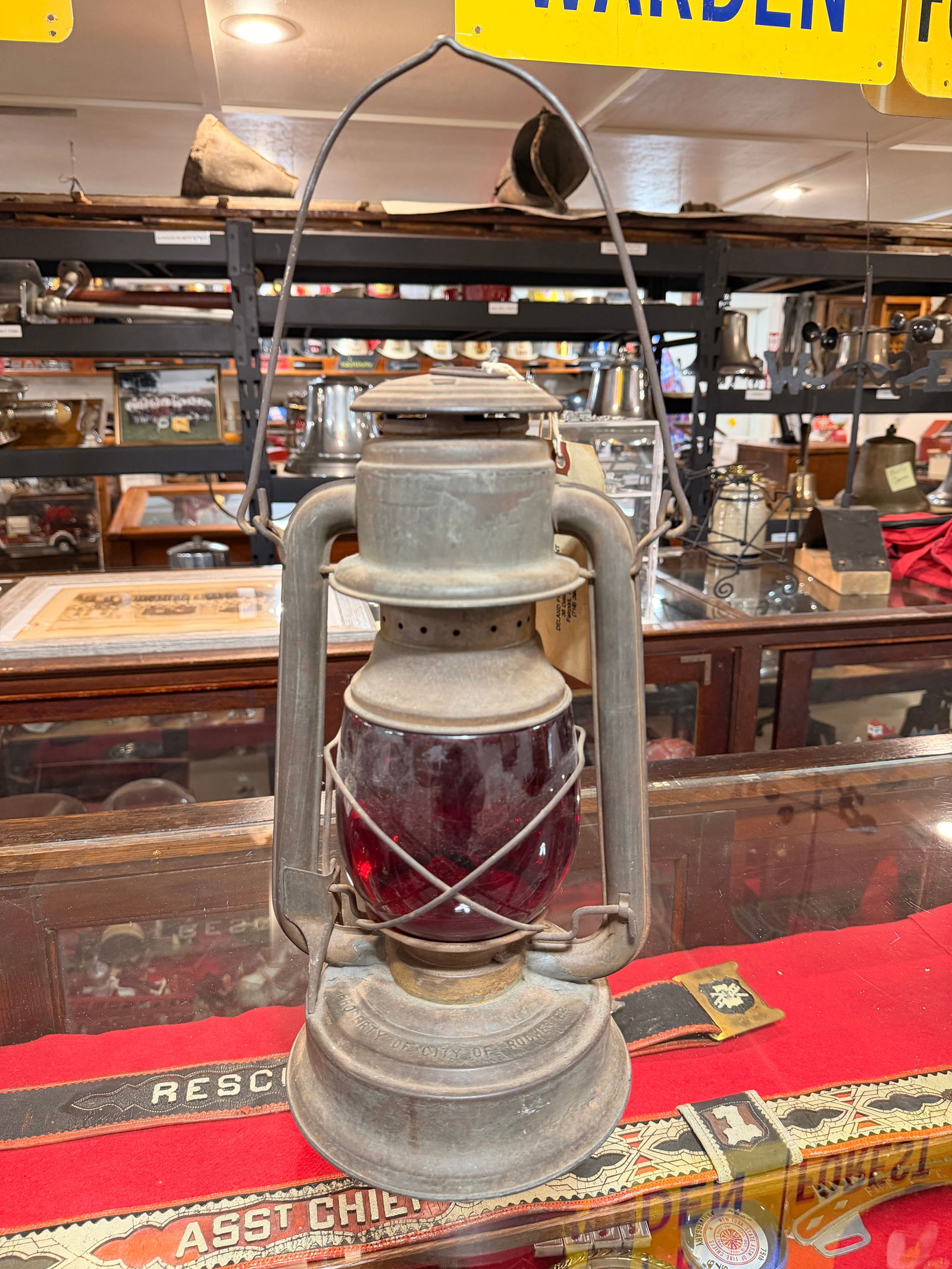 City of Rochester Fire Lantern, Triumph No. 2, Industrial-Style Metal Lantern with Red Glass Globe: An antique City of Rochester Fire Lantern, designated Triumph No. 2. This lantern was utilized by the City of Rochester Fire Department to identify fire hydrants at night. Constructed primarily of
