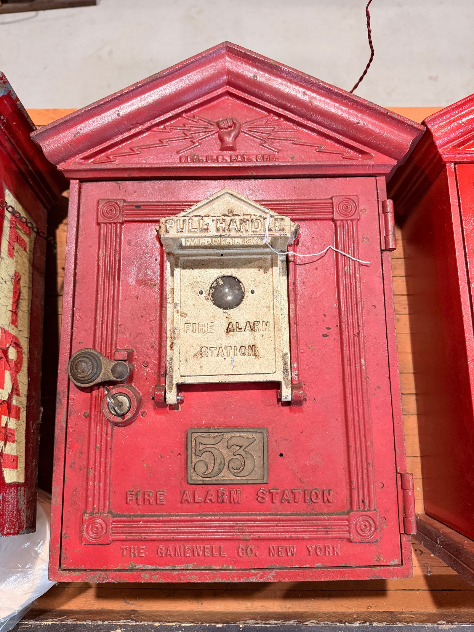A Gamewell Cast Iron Fire Alarm Station, Patented 1924: A Gamewell Style 24, Number 53 Cast Iron Fire Alarm Station, patented January 7, 1924. This vintage, wall-mounted station is primarily constructed of painted red cast iron with brass or bronze