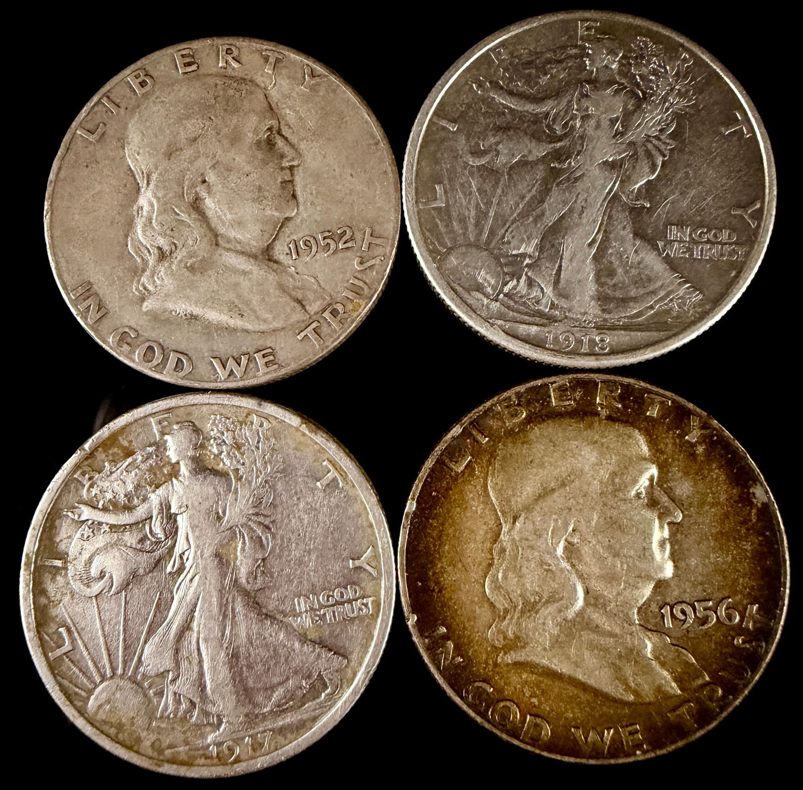 A Group of United States Walking Liberty and Franklin Silver Half Dollars: A group of United States silver half dollars featuring Walking Liberty and Franklin designs. The collection includes Walking Liberty half dollars dated 1917 and 1918, alongside Franklin half dollars d