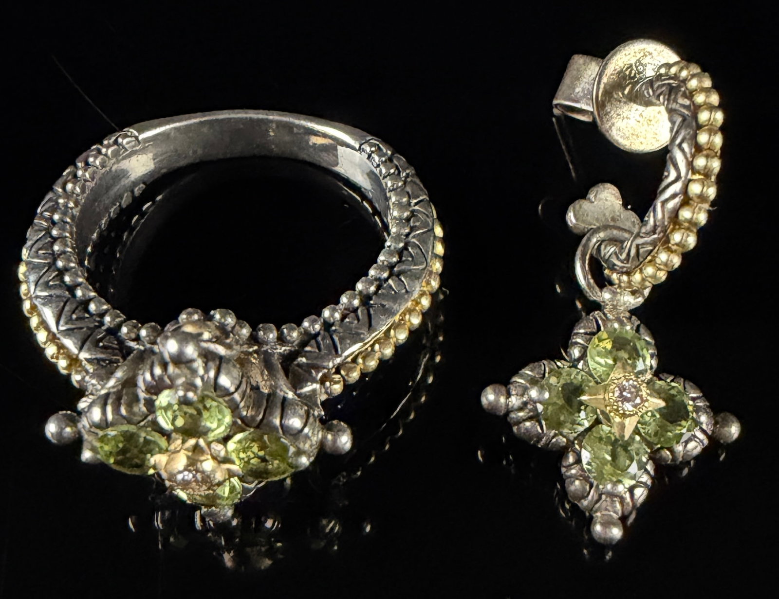 Two Barbara Bixby Sterling Silver and 18K Gold Peridot Jewelry Items: A Barbara Bixby sterling silver and 18k yellow gold ring and matching drop earring. Each piece features a signature four-lobed floral motif set with four faceted peridot gemstones surrounding a centra