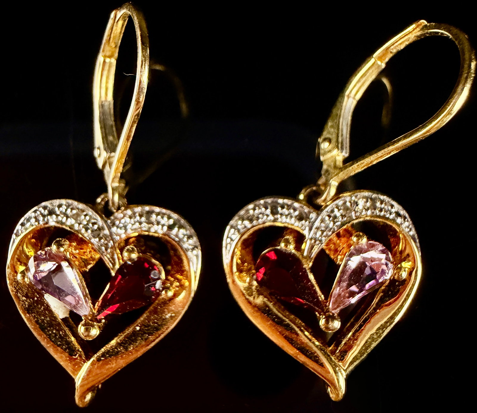 A Pair of Gold-Plated Sterling Silver and Gemset Heart-Shaped Dangle Earrings: A pair of contemporary gold-plated sterling silver dangle earrings featuring a heart-shaped motif. Each earring is designed with a lever-back closure supporting a heart pendant accented by a row of sm