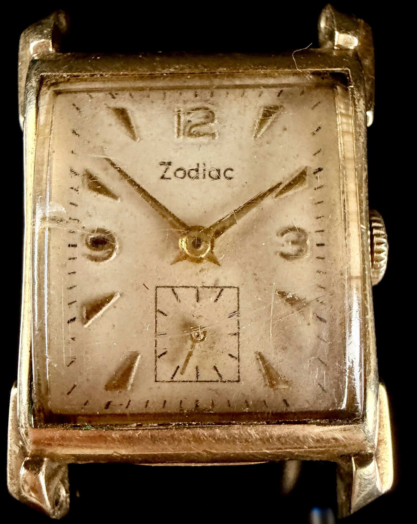 A Vintage Zodiac Art Deco Rectangular 10K Gold Filled Wristwatch Head: Does not run, This Zodiac wristwatch head features a rectangular tank-style case constructed from 10K gold-filled metal. The silver-tone dial exhibits significant patina and includes applied gold-tone