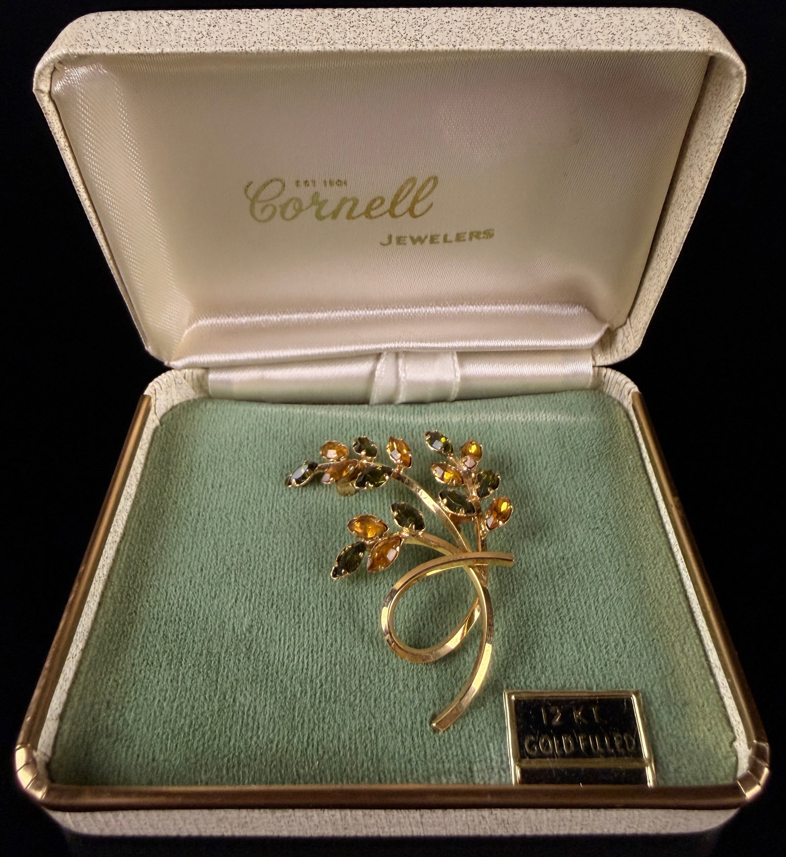 W.E. Richards 12KT Gold-Filled and Rhinestone Botanical Spray Brooch: A 12KT gold-filled brooch by W.E. Richards Co. featuring a botanical spray design. The piece is constructed with a looped, polished stem and set with faceted marquise-cut rhinestones in alternating am