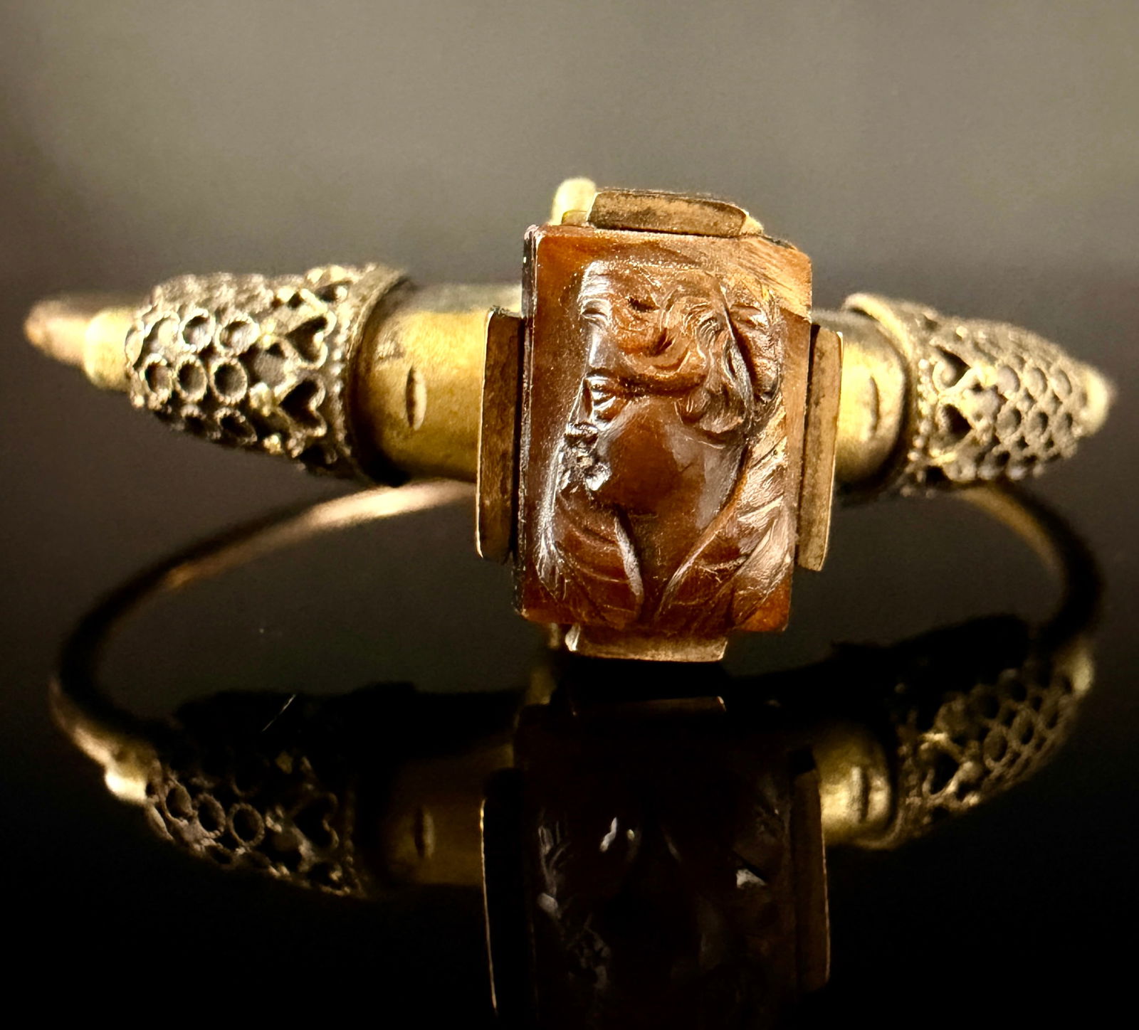 Victorian Gold Filled Tiger's Eye Quartz Cameo Bangle Bracelet: hinge is a little loose A Victorian-style bangle bracelet featuring a central rectangular carved tiger's eye quartz cameo depicting a classical profile bust in relief. The cameo is secured in a gold f