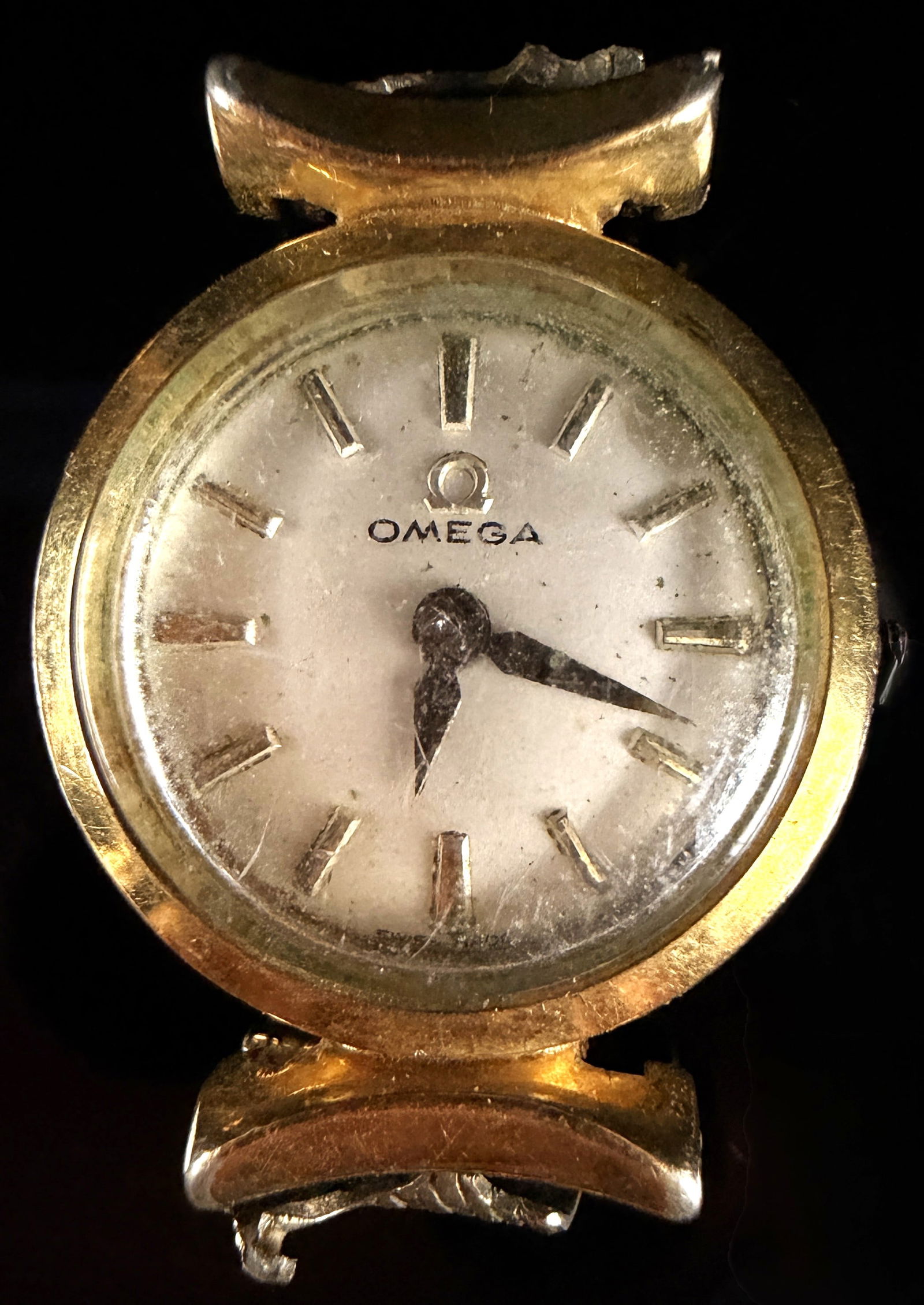 A Vintage Omega Gold FIlled Ladies Cocktail Watch Head: A vintage Omega ladies' cocktail wristwatch head. The circular case features a yellow gold bezel and a stainless steel snap-back. The silvered dial displays applied gold-toned baton hour markers and