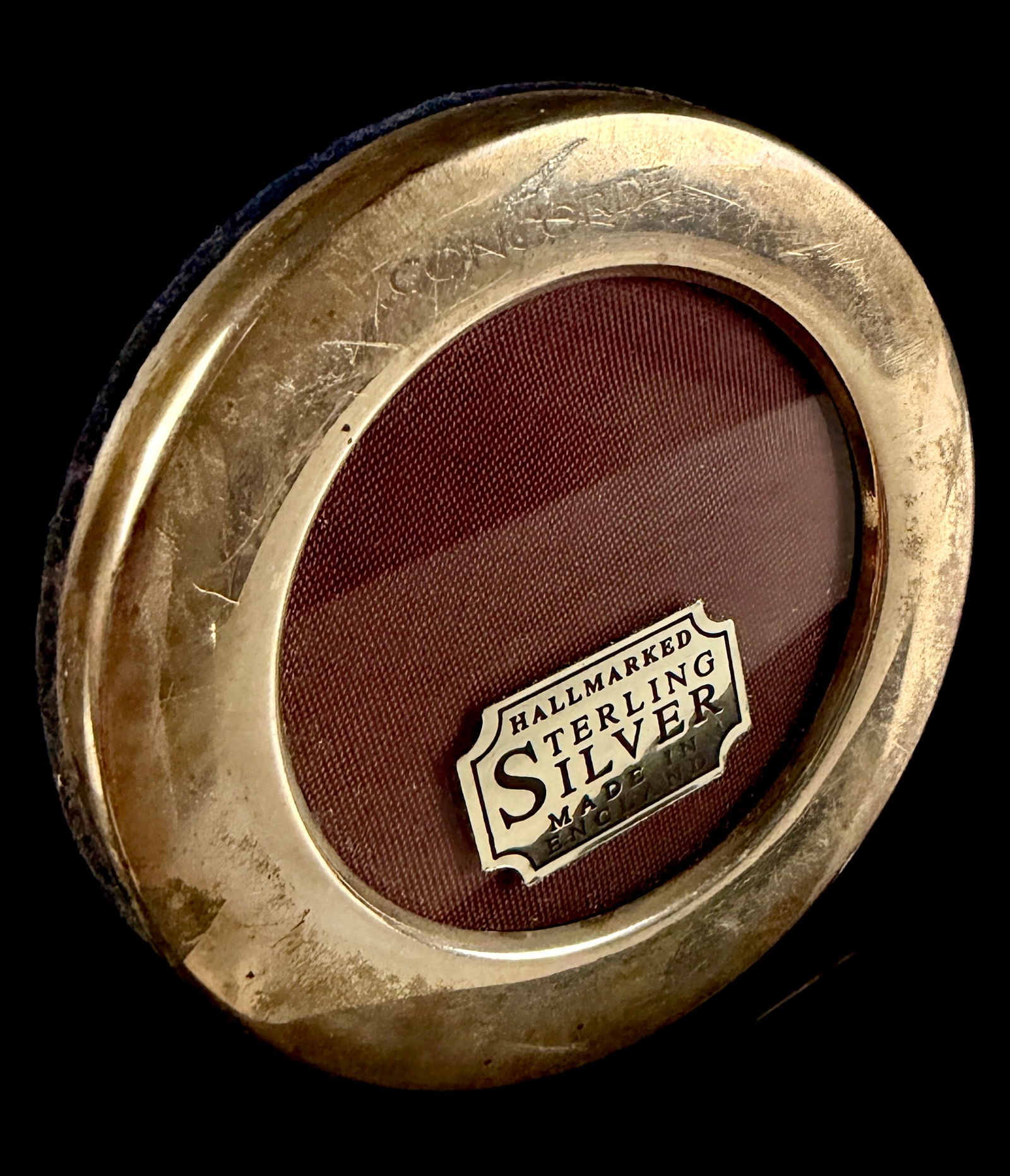 British Airways Concorde Sterling Silver Miniature Picture Frame: This circular sterling silver miniature picture frame is a British Airways Concorde commemorative item. The polished silver bezel is engraved with the name CONCORDE alongside the aircraft's stylized d