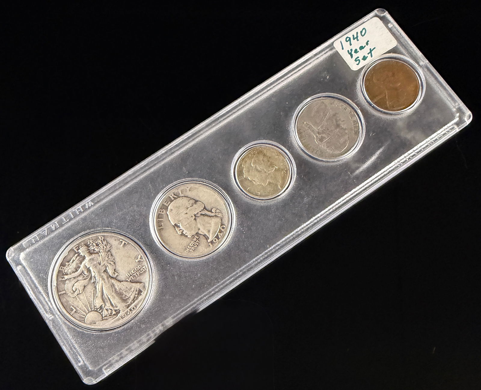 1940 United States Year Set in Whitman Case: A 1940 United States Year Set comprising five coins of various denominations. The collection includes a Walking Liberty silver half dollar, a Washington silver quarter, a Mercury silver dime, a Jeffer